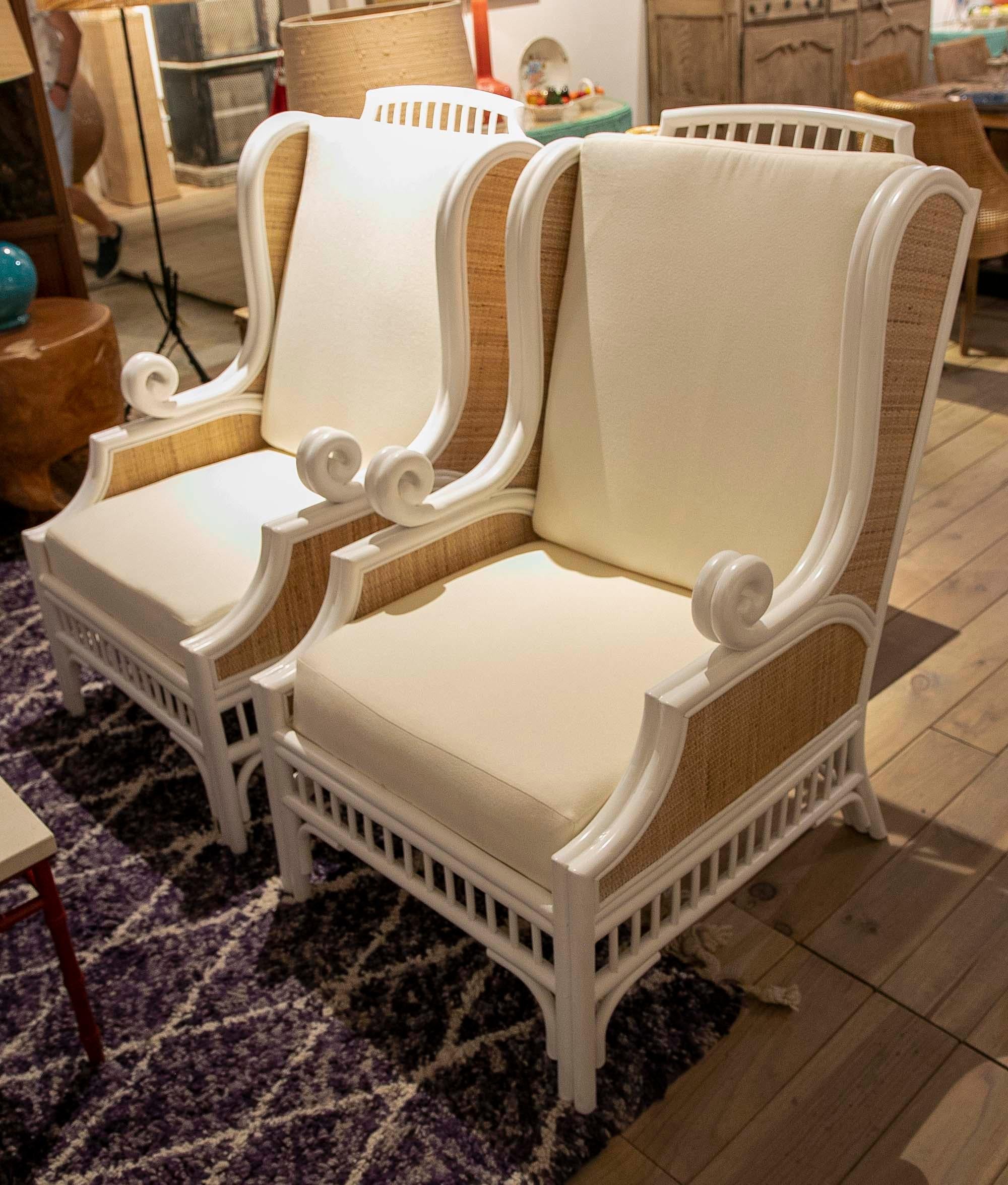 European Pair of White Lacquered Rattan Armchairs Lined on the Sides with Cushions For Sale