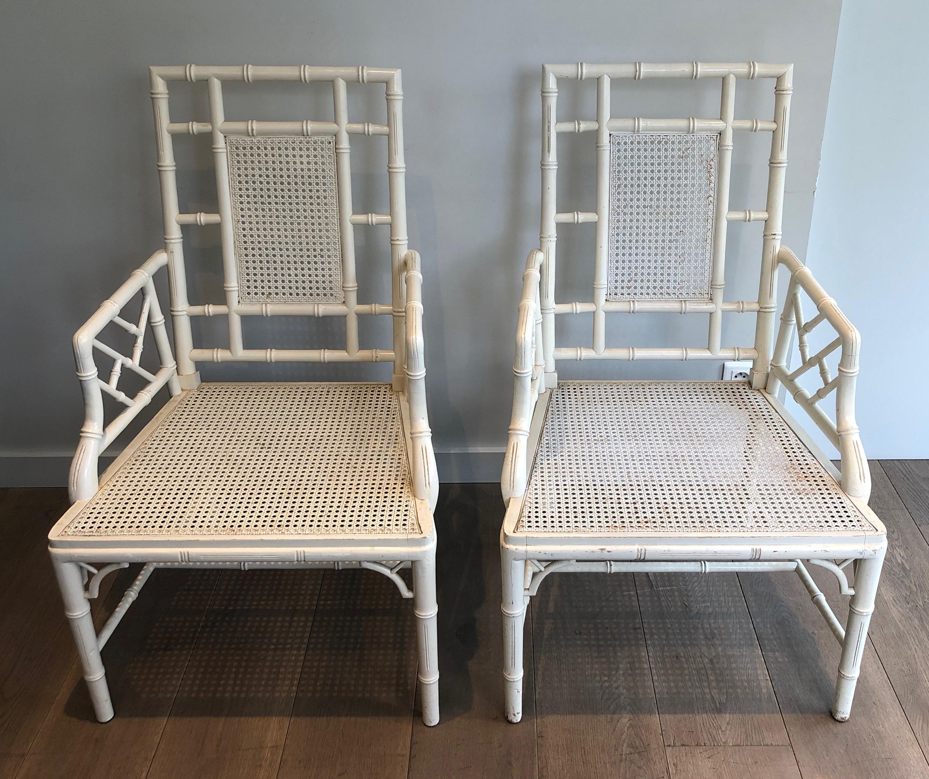 This very nice pair of faux-bamboo armchairs is made of a white lacquered wood. This is a French work in the style of Chinese Chippendale and in the style of famous French designer Maison Jansen. Circa 1970.