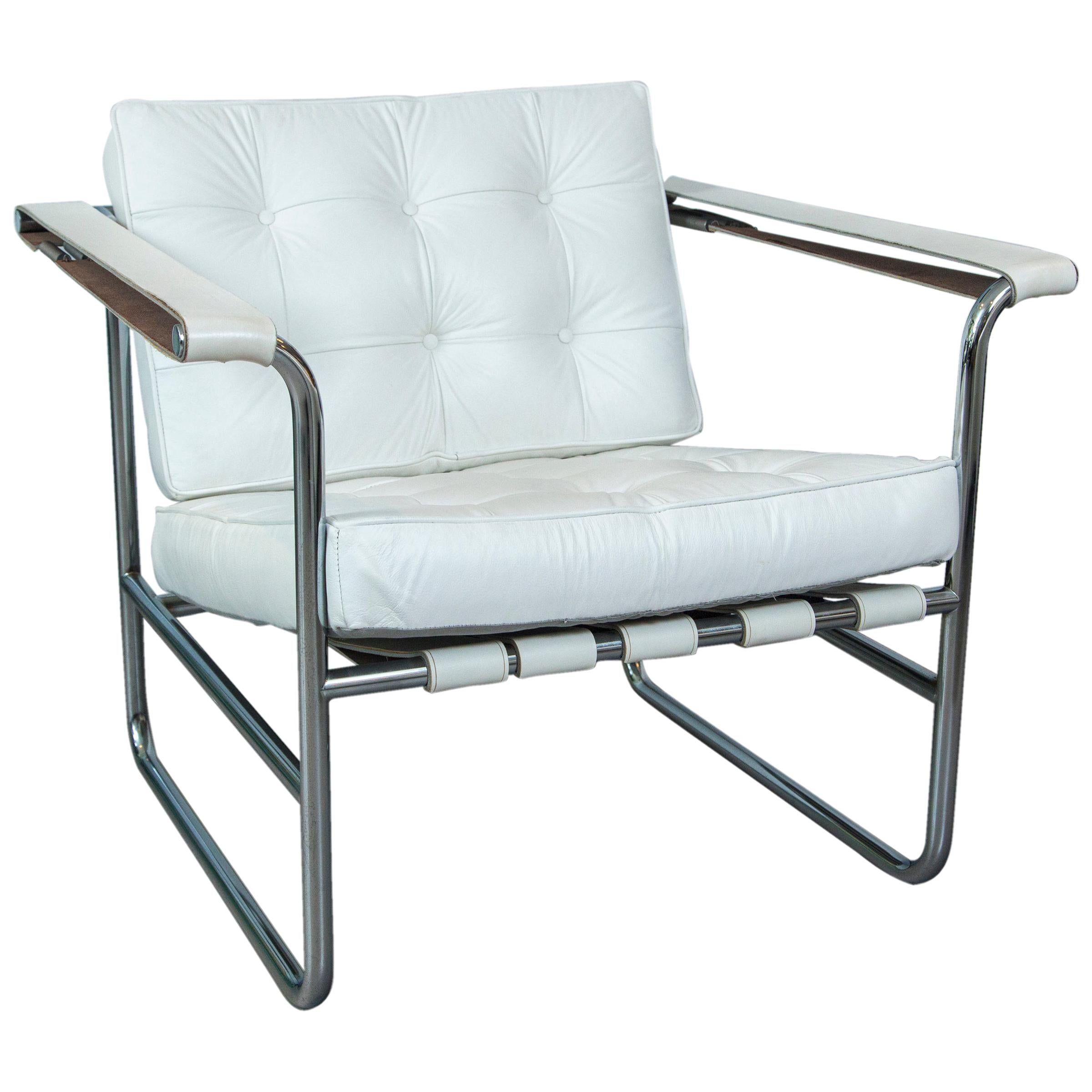 A pair of chrome tubular metal and tufted white leather lounge chairs produced by Stendig, Switzerland.