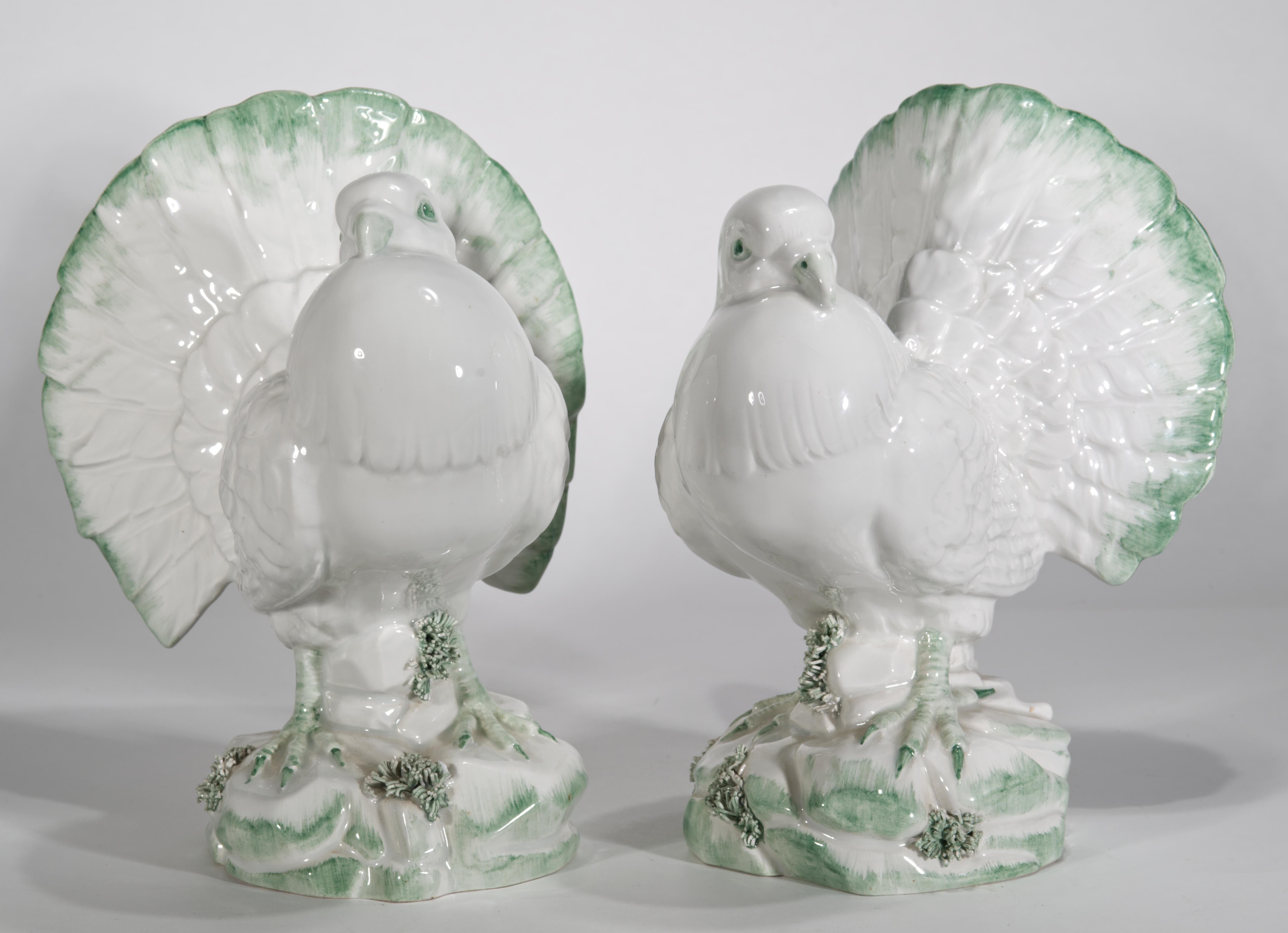 The vintage porcelain or ceramic dove figurines feature finely detailed bodies, artfully hand painted with light green accents on bright white majolica glaze, creating a reserved, natural color palette of white and tone-on-tone green.

The birds are
