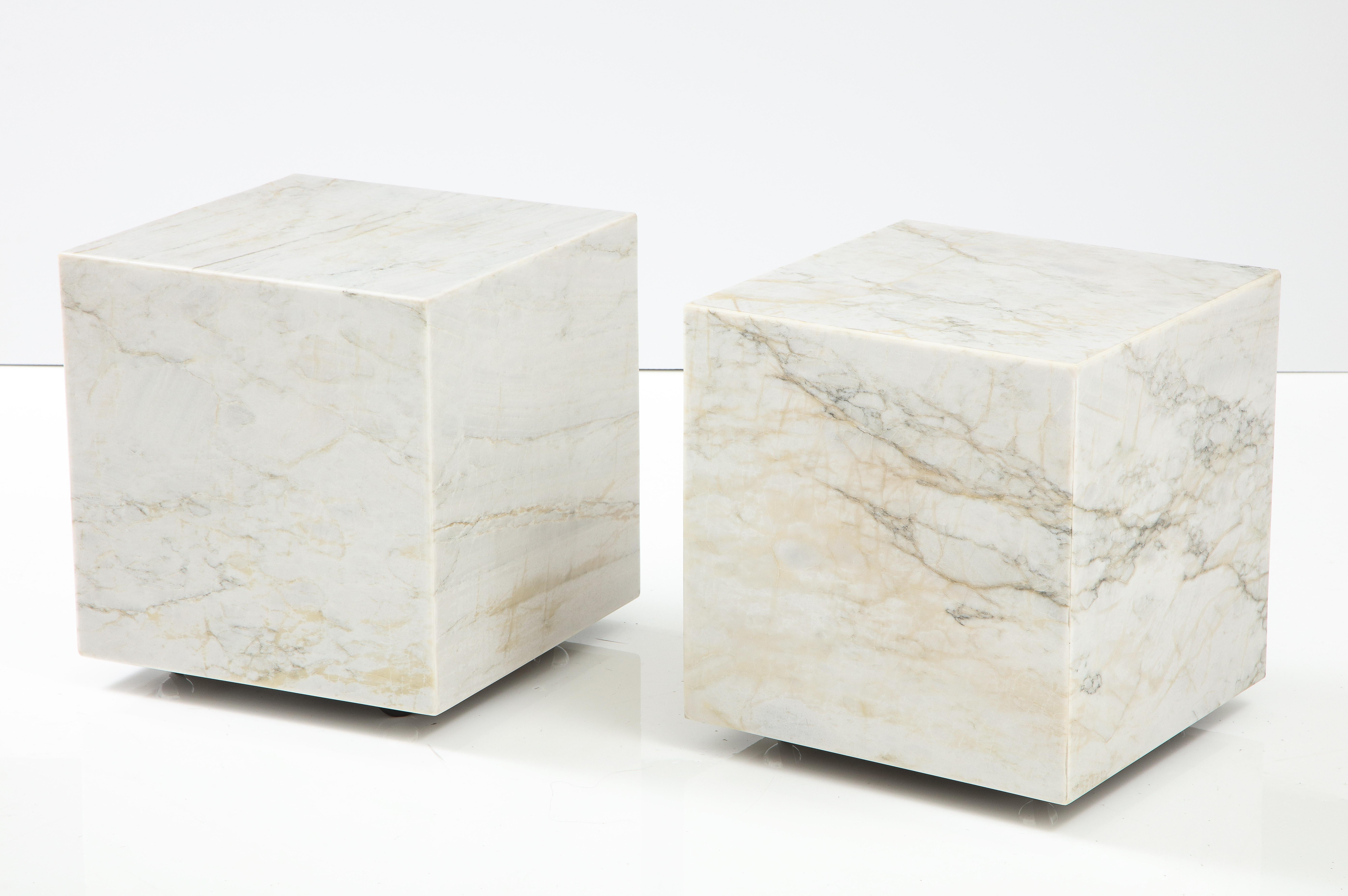 Pair of white marble cube tables.
The marble has beautiful veining and they can be used separately as end tables or
joined together to form a coffee table.
The tables have new chrome casters for easy movement.