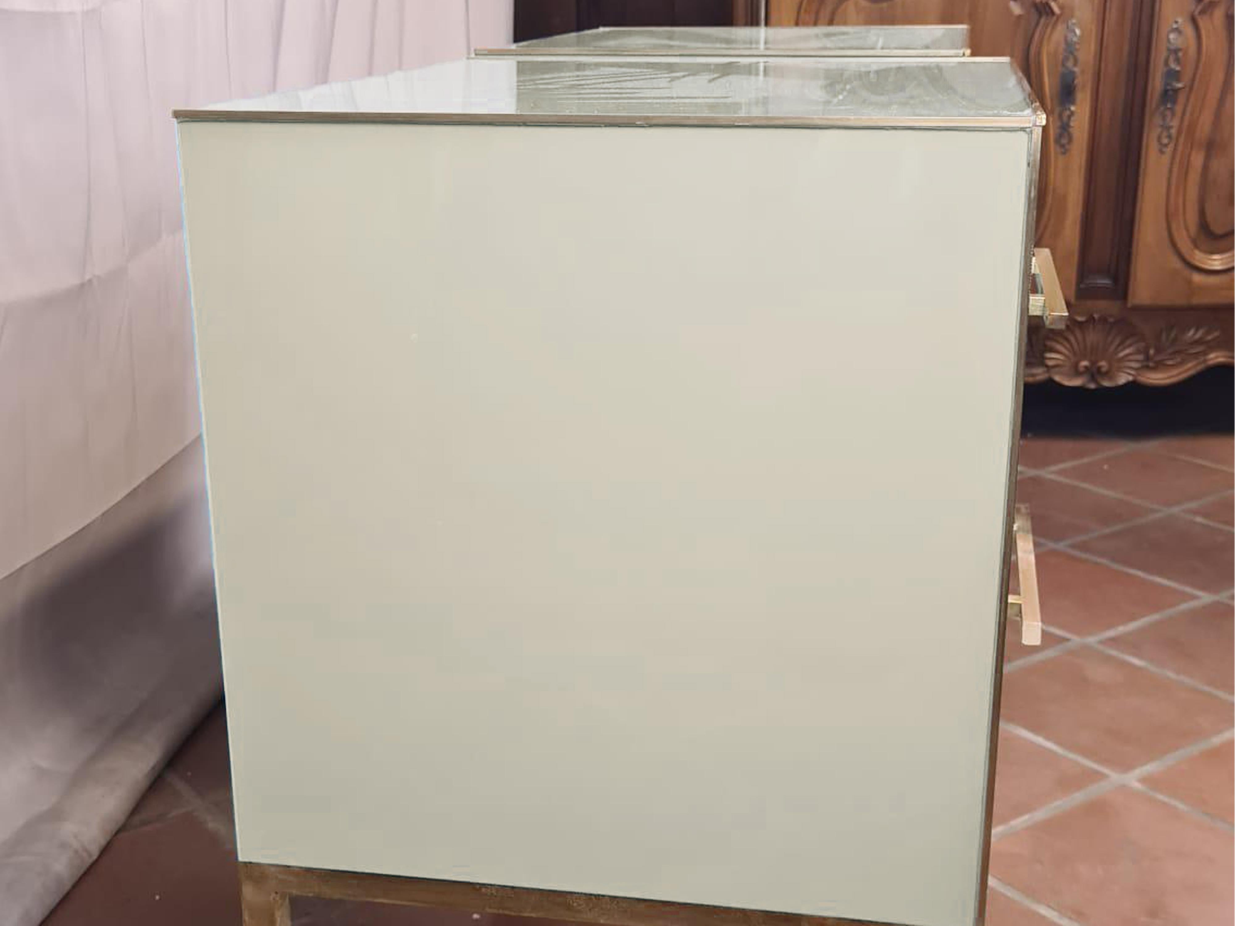 This pair of white Murano opaline bedside tables with brass fittings and legs is a splendid example of mid-century modern design, handcrafted in Italy. 

Each piece features a white Murano glass top and drawers, complemented by a sturdy birch wood