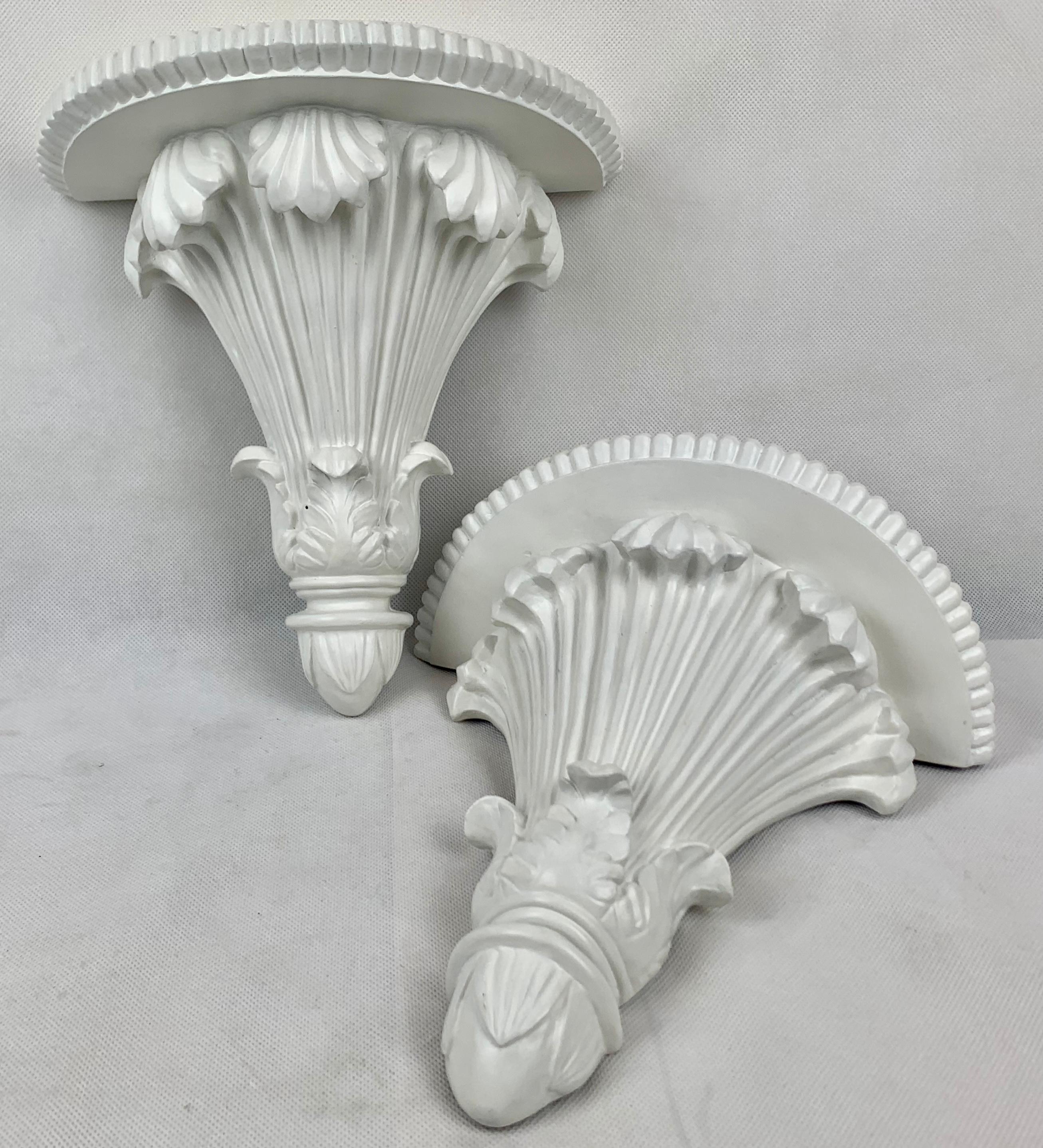Pair of white neo-classical wall brackets. The half round top shelves have a fluted edge. The body of the bracket has shell forms at the top and acanthus leaves at the base, all references to neo-classicism.
Mid twentieth century.
Measures:
