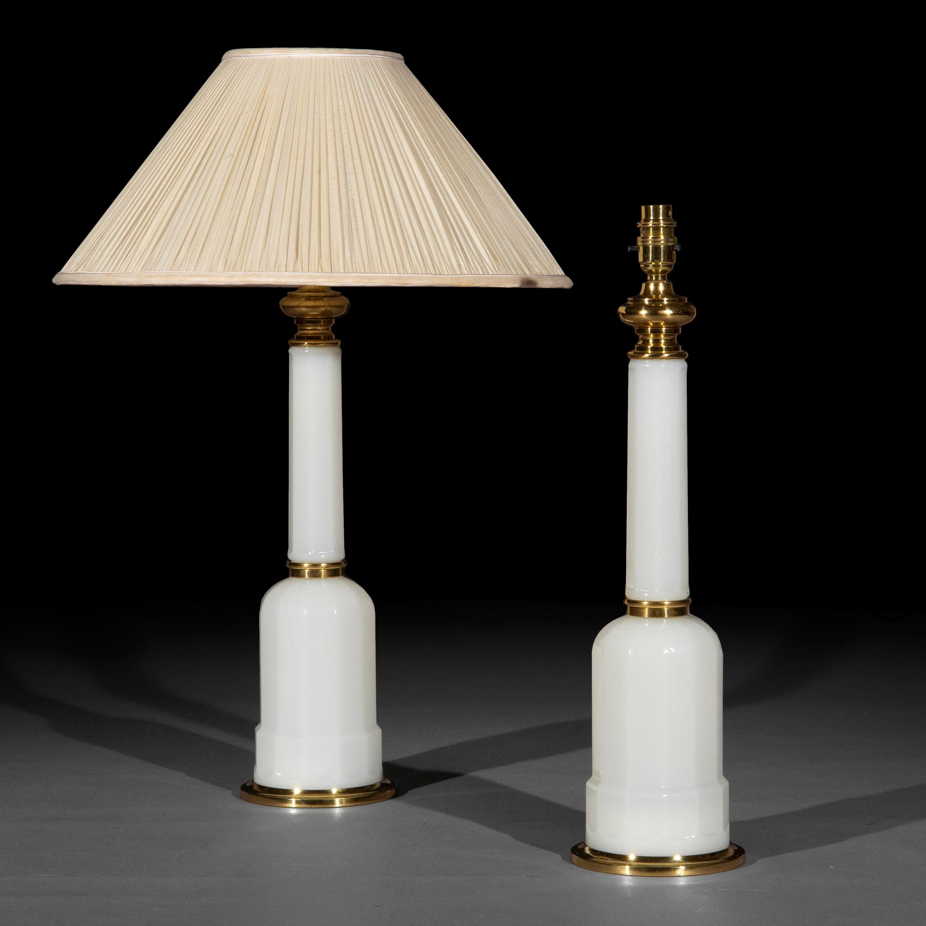 A stylish pair of white opaline glass and bass table lamps of superb quality, fashioned as 19th century oil lamps.

France, early to mid-20th century.

Why we like them
Their iconic, timeless design makes these lamps look understated and