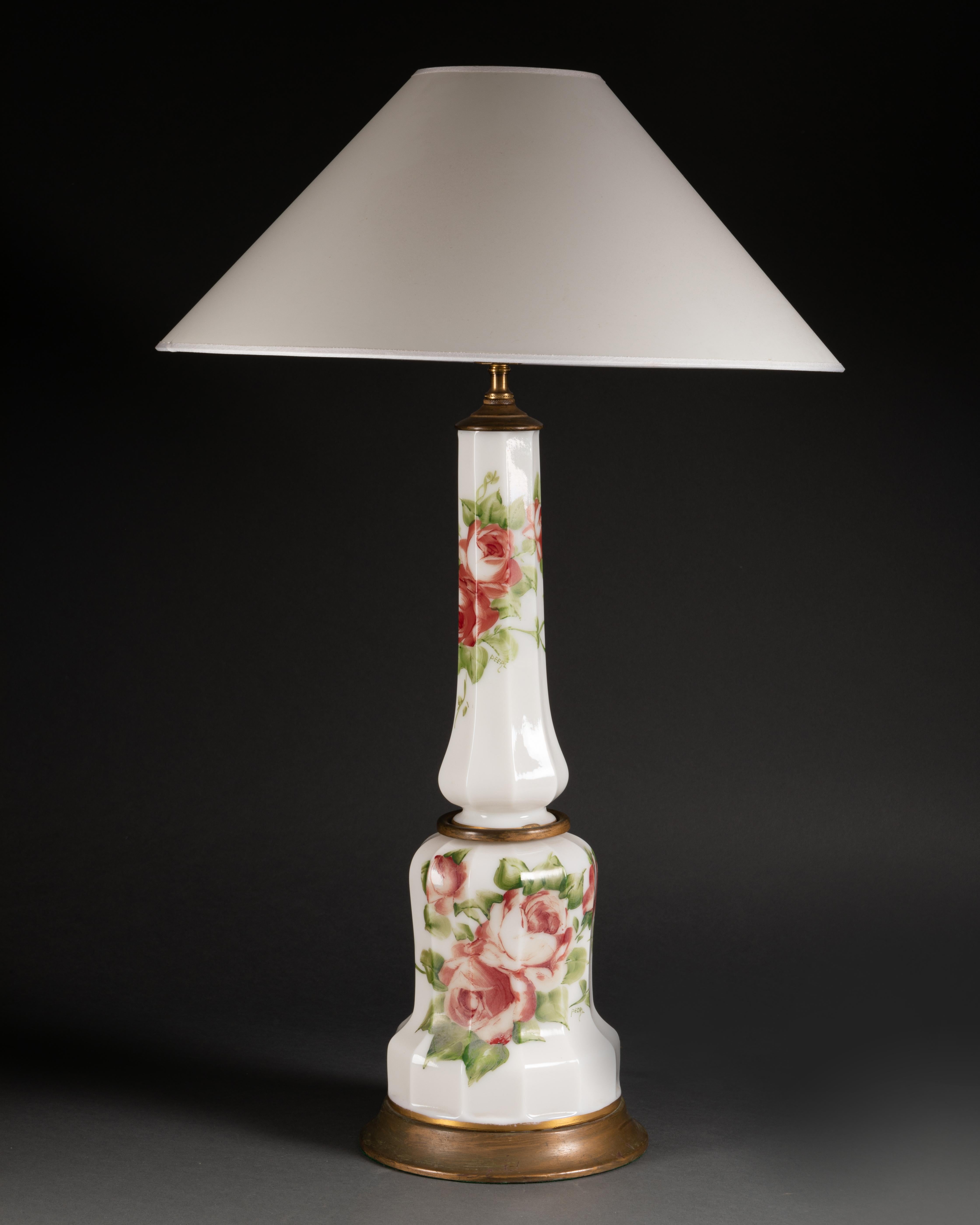 Pair of white overlay glass lamps with hand painted roses. French or English, circa 1920. Wired to the EU standard. Sold with or without lampshade. Height to socket 60 cm.