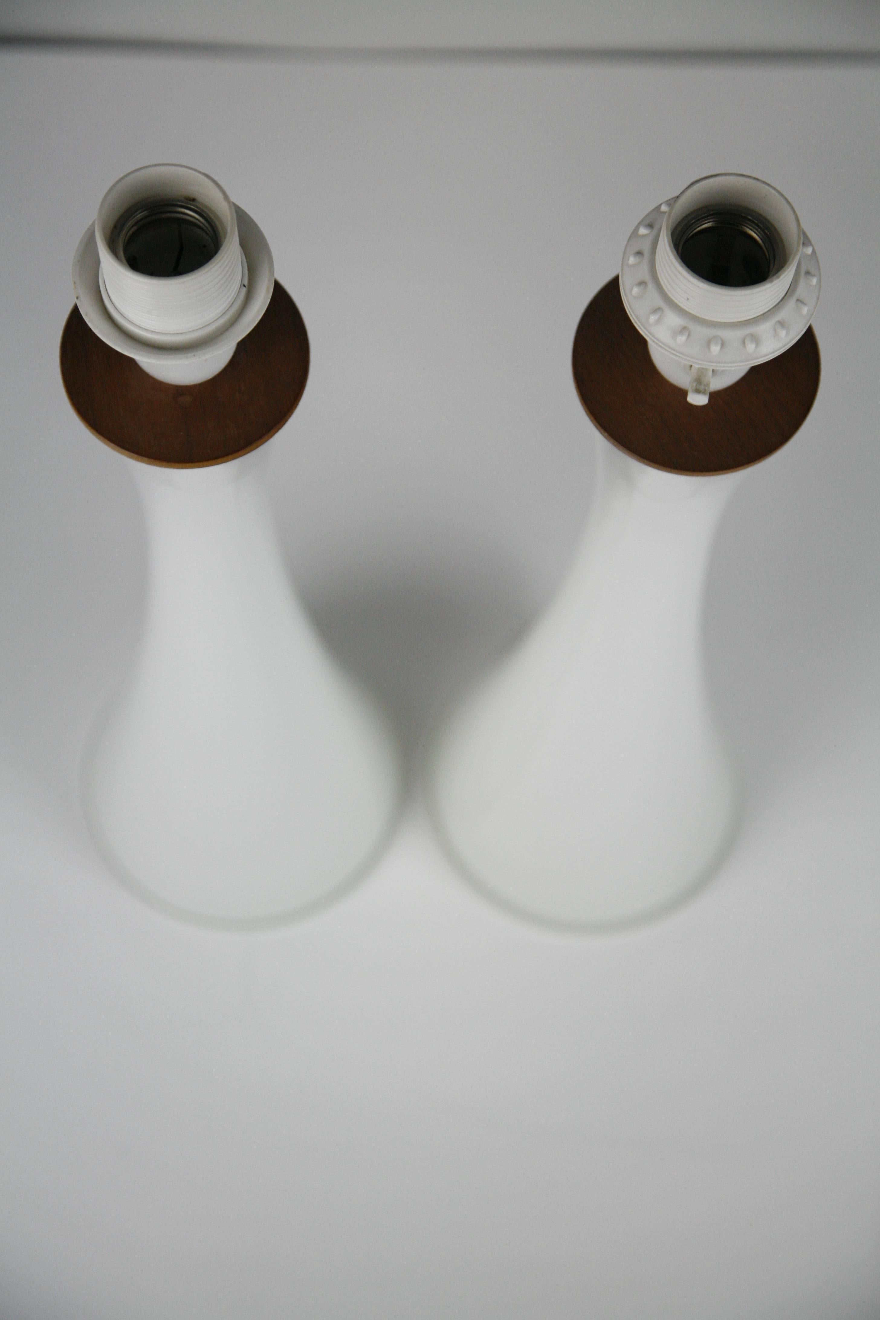 Pair of opaline glass lamps by Bergboms, Sweden, 1960.
White glass incased of a layer of white matte glass with teak tree fittings, modern Classic Scandinavian clean look.

Rewired for the US.