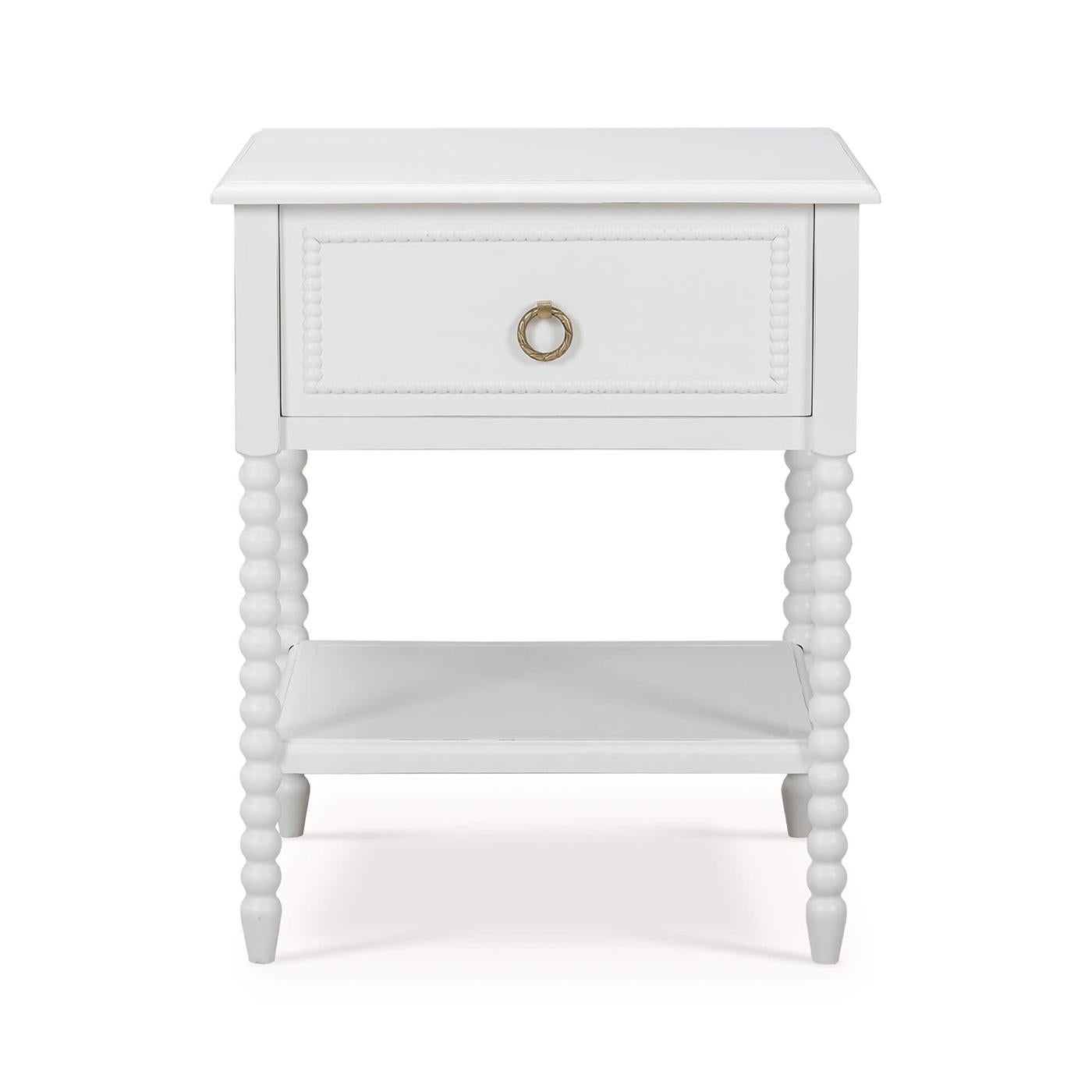 This beautifully crafted piece features a lightly distressed architectural white painted finish that complements almost any decor style. The delicate ring pulls add a hint of sophistication, making this table a perfect addition to both traditional