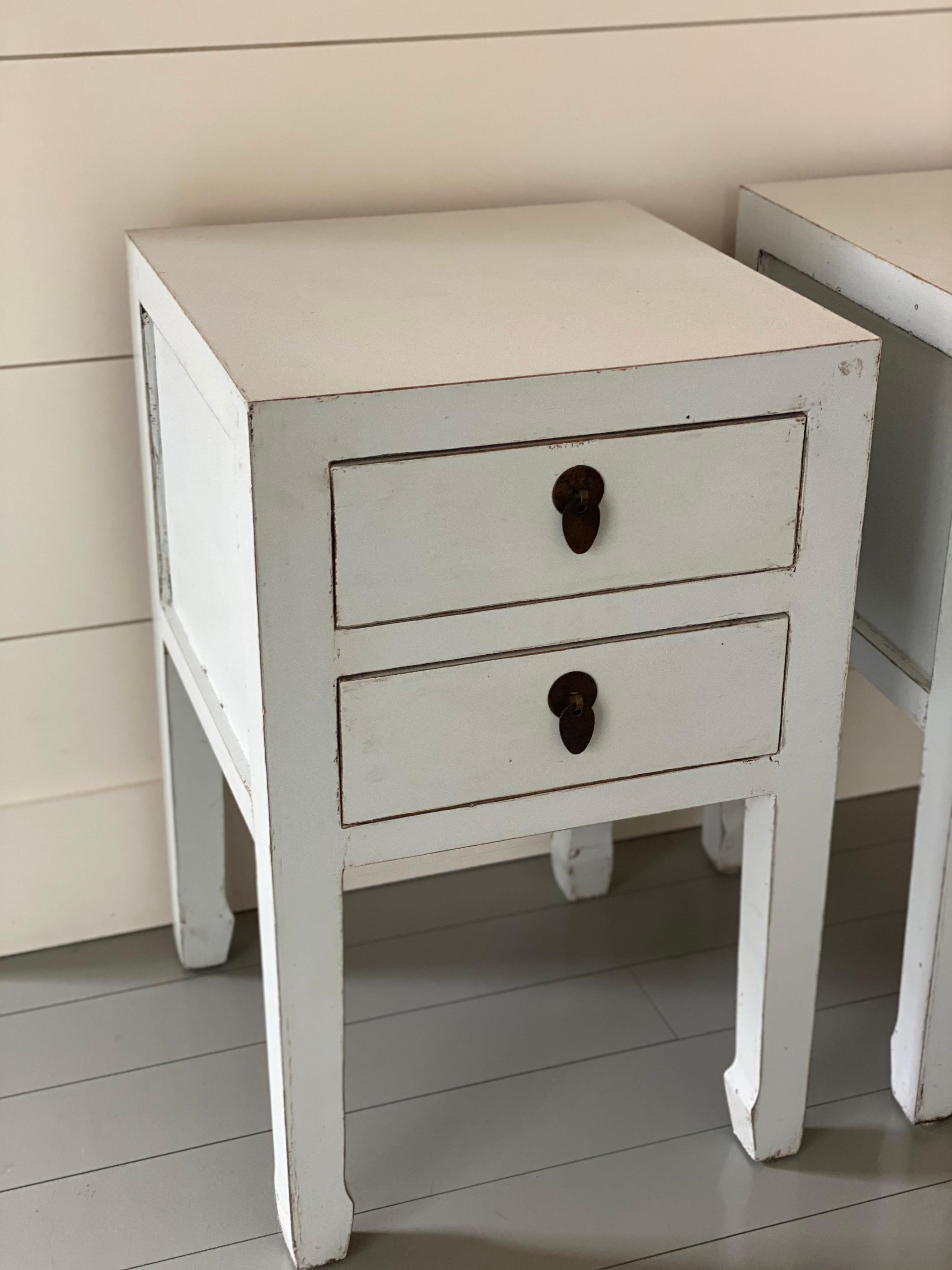 Pair of white painted two drawer Chinese style end tables
Two drawers

Expected wear to finish. Overall good condition.

Measurements: 
Width: 15.75 in
Depth: 14 6/8 in
Height: 24 in.