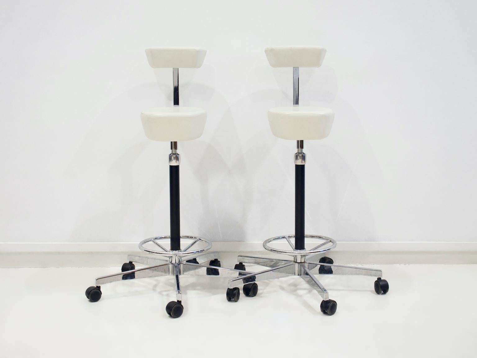 Pair of white leather stools or 'Perch Chairs' by George Nelson for Vitra. Designed 1964. This pair is manufactured in 2010 by Vitra. Some signs of use - marks, scratches.
