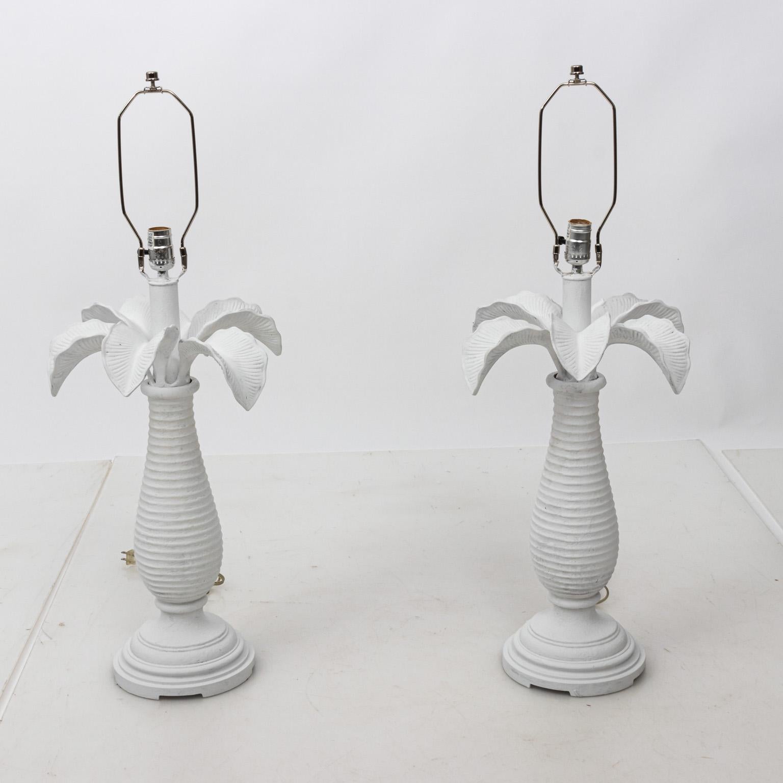 Pair of white plaster palm tree shaped table lamps with vase turned base. Shades not included. Please note of wear consistent with age including minor chips to white finish.
