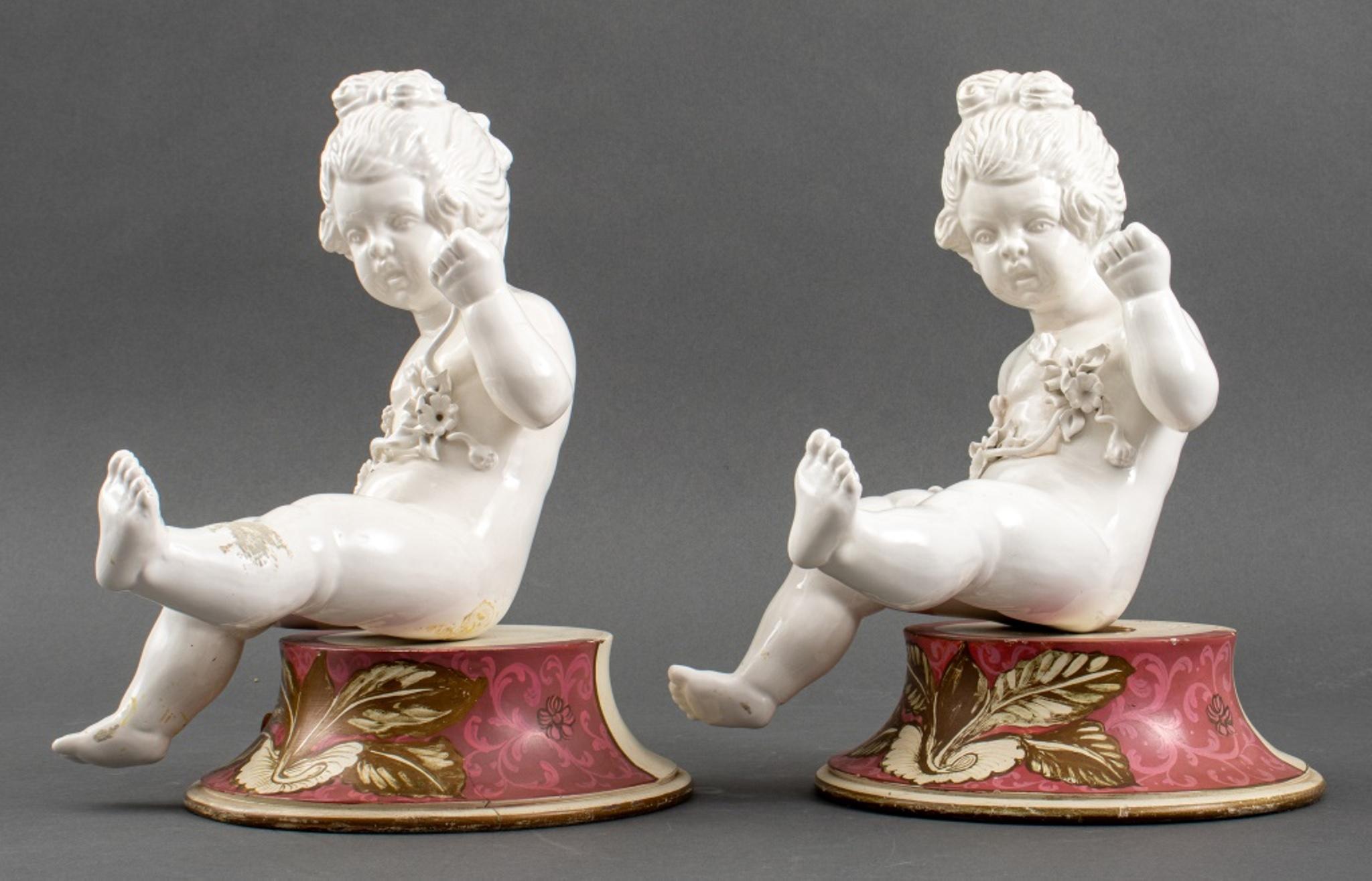 Pair of vintage white porcelain cherub putti sculptures holding molded branches with flowers, mounted on polychrome and gilt painted wood bases. In very good vintage condition.

Dealer: S138XX