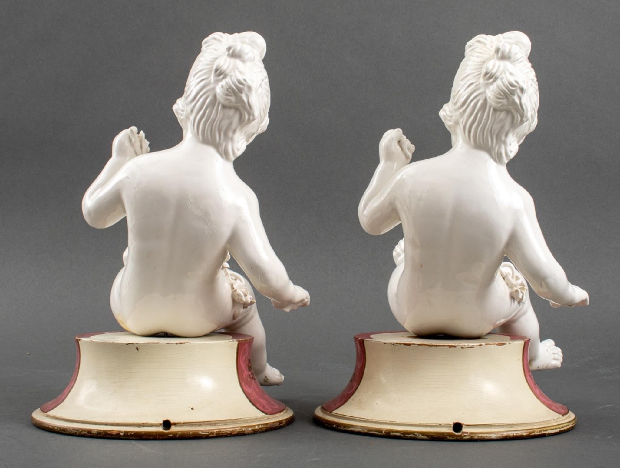Pair of White Porcelain Cherub Putti Sculptures In Good Condition For Sale In New York, NY