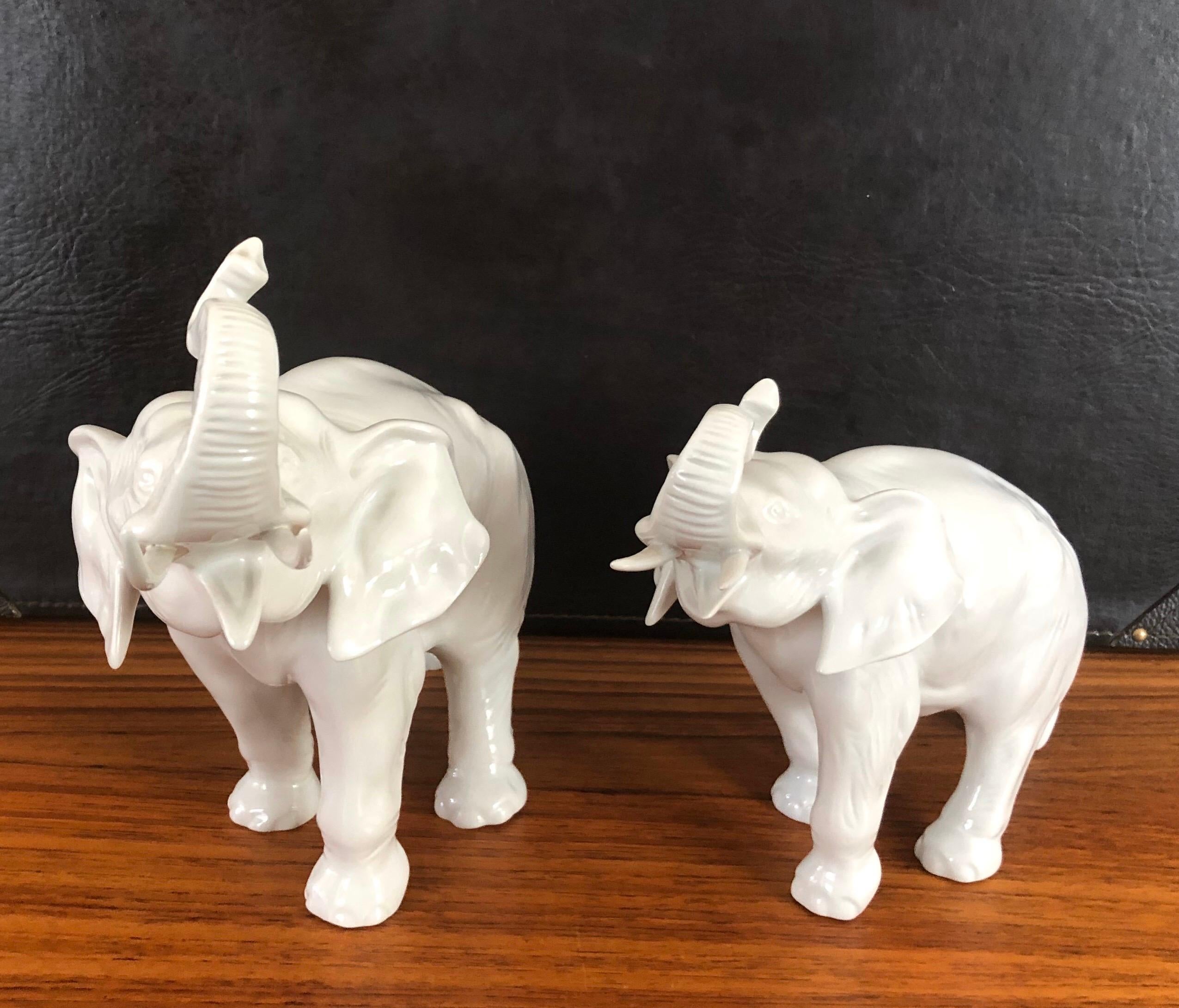 Gorgeous pair of white porcelain elephant sculptures by Royal Dux of the Czech Republic, circa 1970s. Impressive detail and a stunning high gloss finish. The pair are in excellent condition with no chips, cracks or crazing. The large elephant