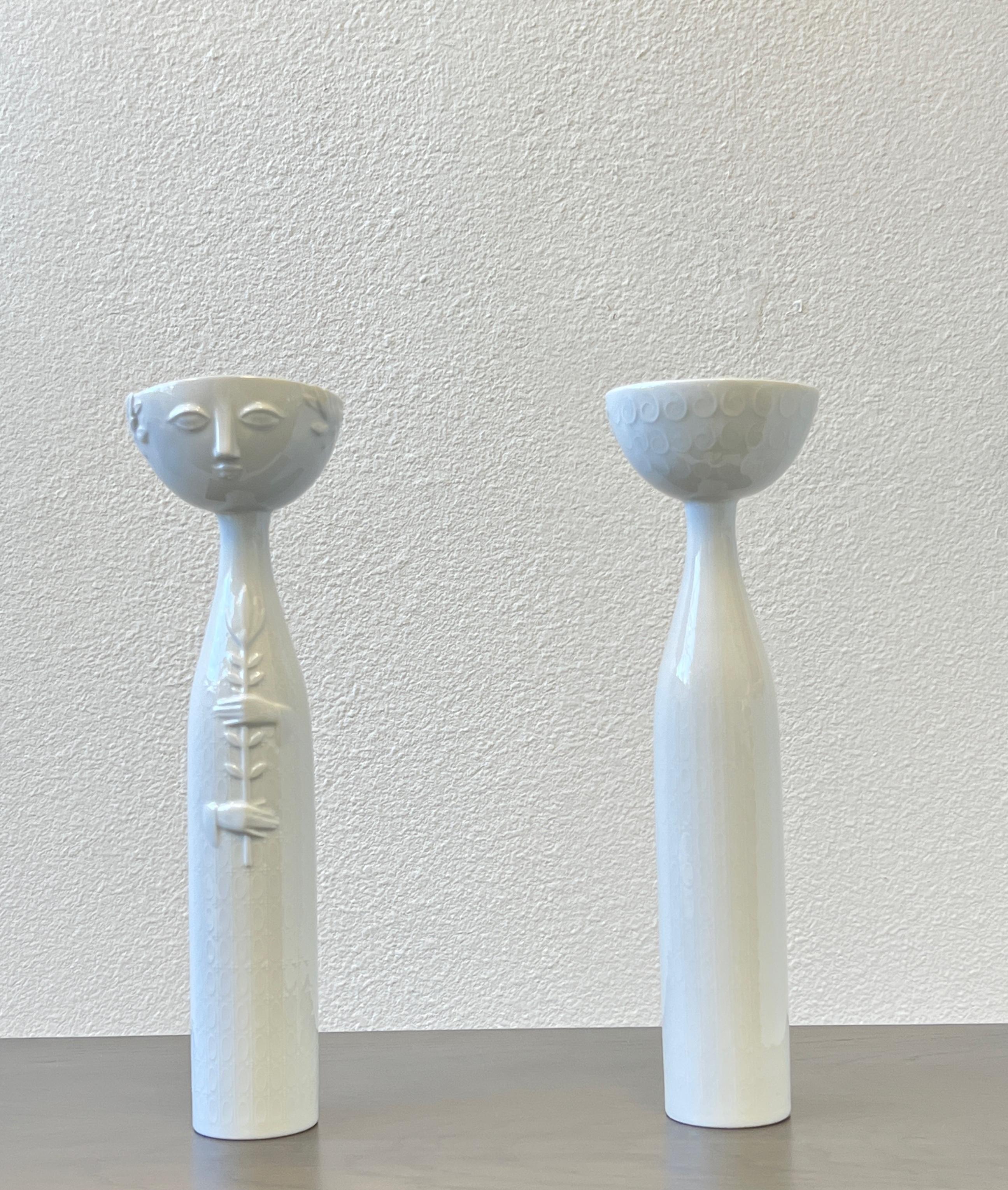 A beautiful pair of 1970’s white porcelain Eva candle holders or vases by renowned Danish Painter Bjorn Wiinblad for Rosenthal Studio Linie  Germany. 
Both are signed.
Measurements: 14.5” High, 4.25” Wide, 4” Deep. 