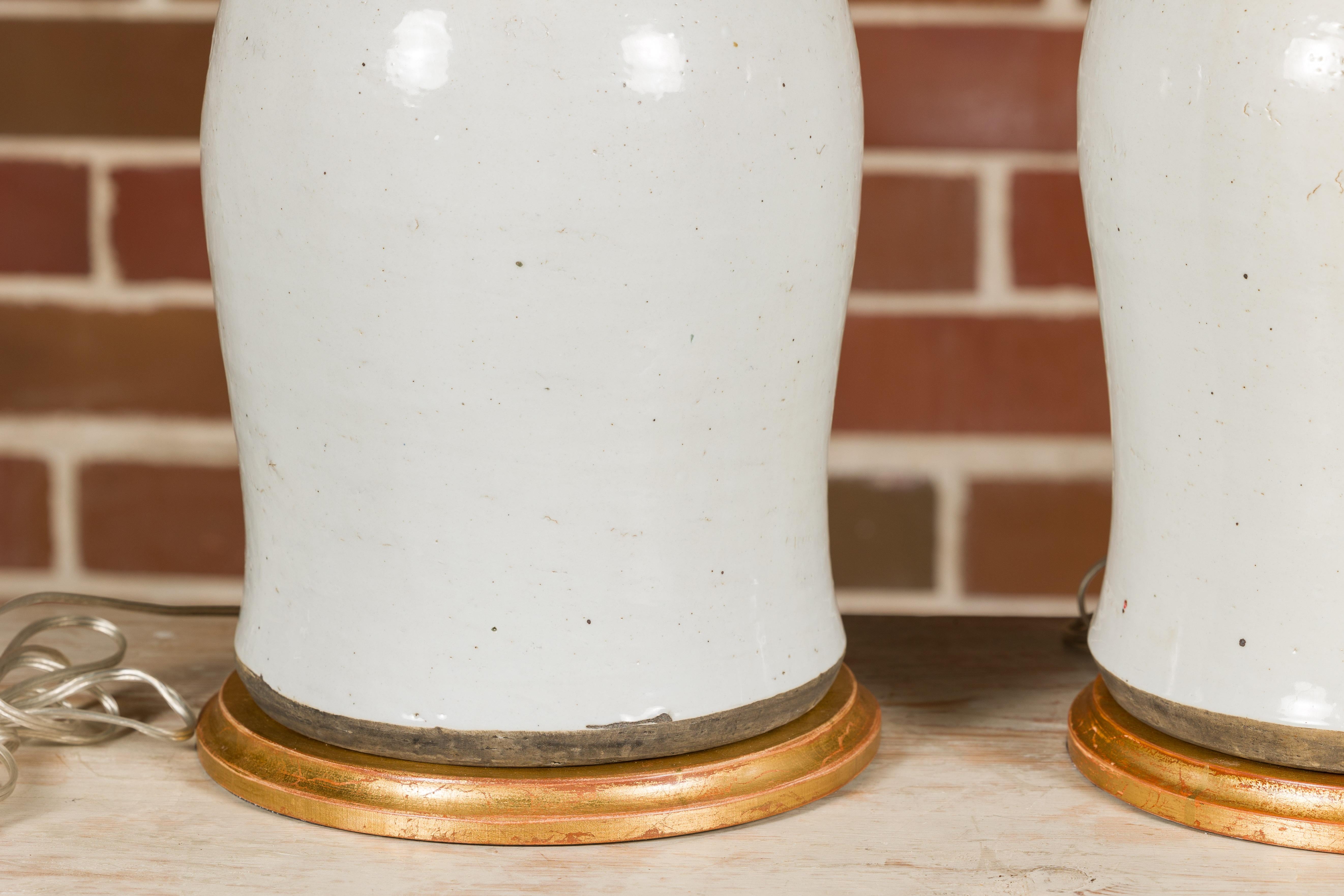 Pair of White Porcelain Lidded Urns Made into Table Lamps on Gilded Bases For Sale 9