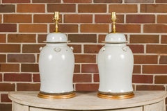 Pair of White Porcelain Lidded Urns on Gilded Bases, Wired for the USA