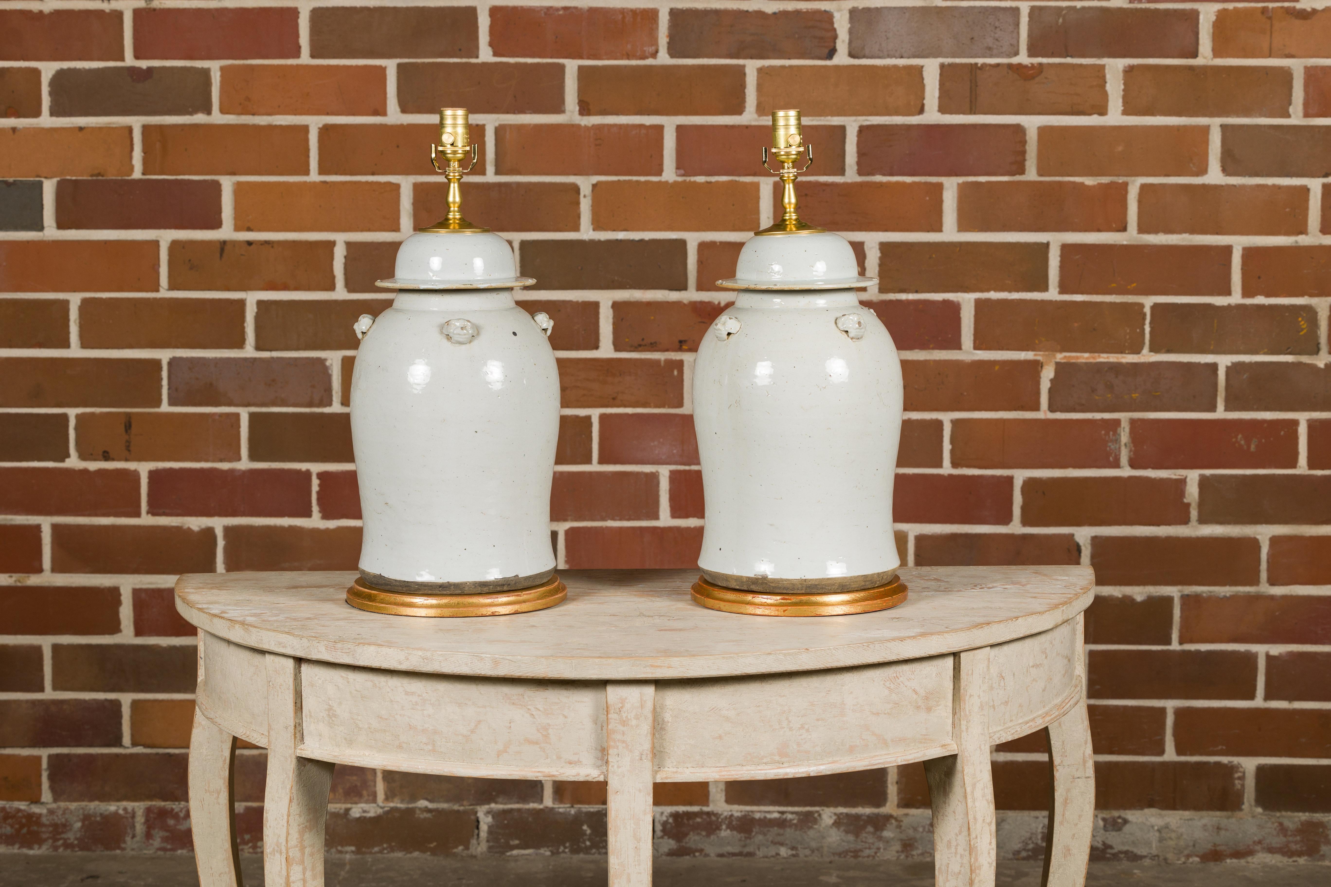 Gilt Pair of White Porcelain Lidded Urns Made into Table Lamps on Gilded Bases For Sale