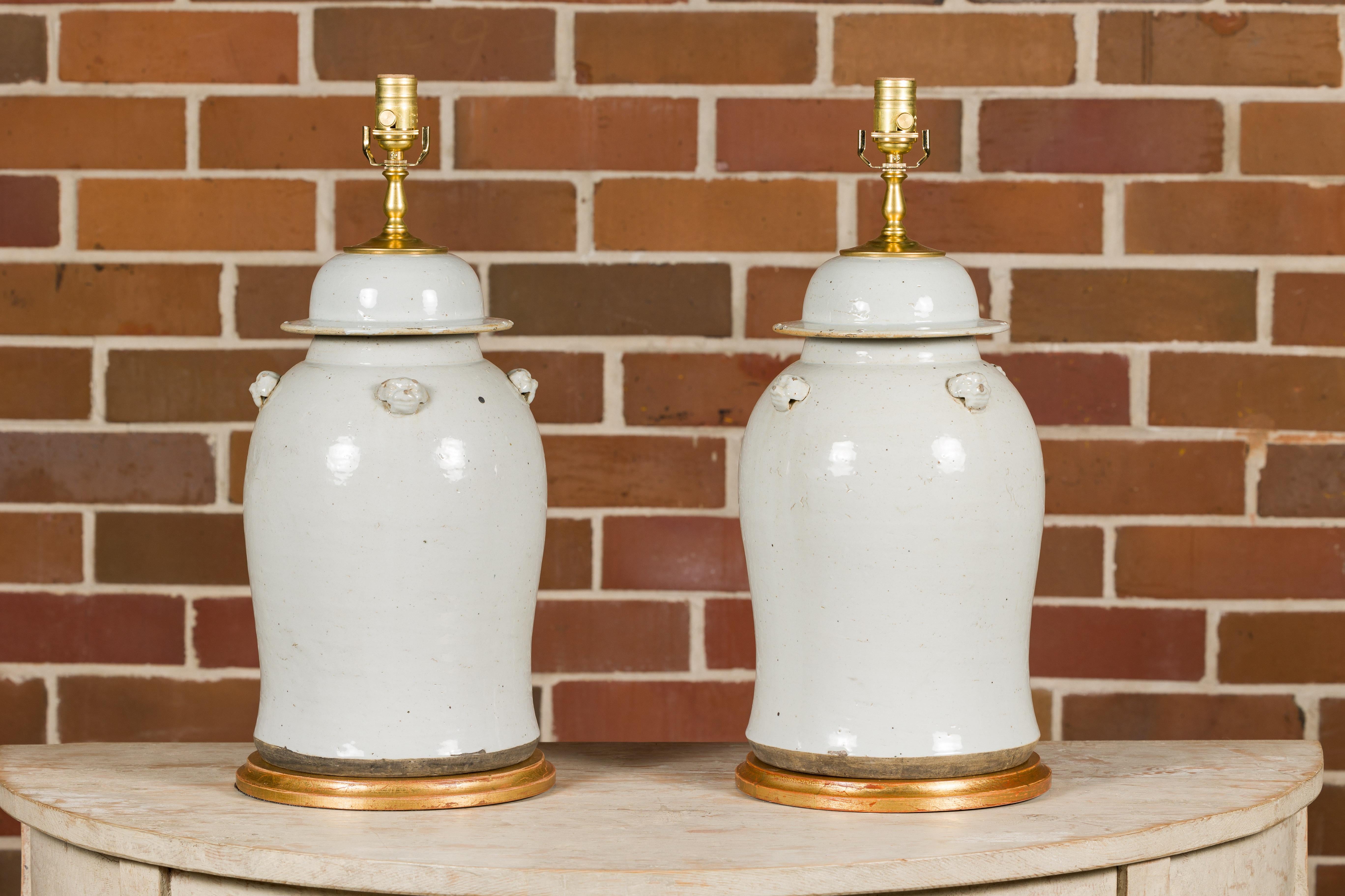 Pair of White Porcelain Lidded Urns Made into Table Lamps on Gilded Bases In Good Condition For Sale In Atlanta, GA