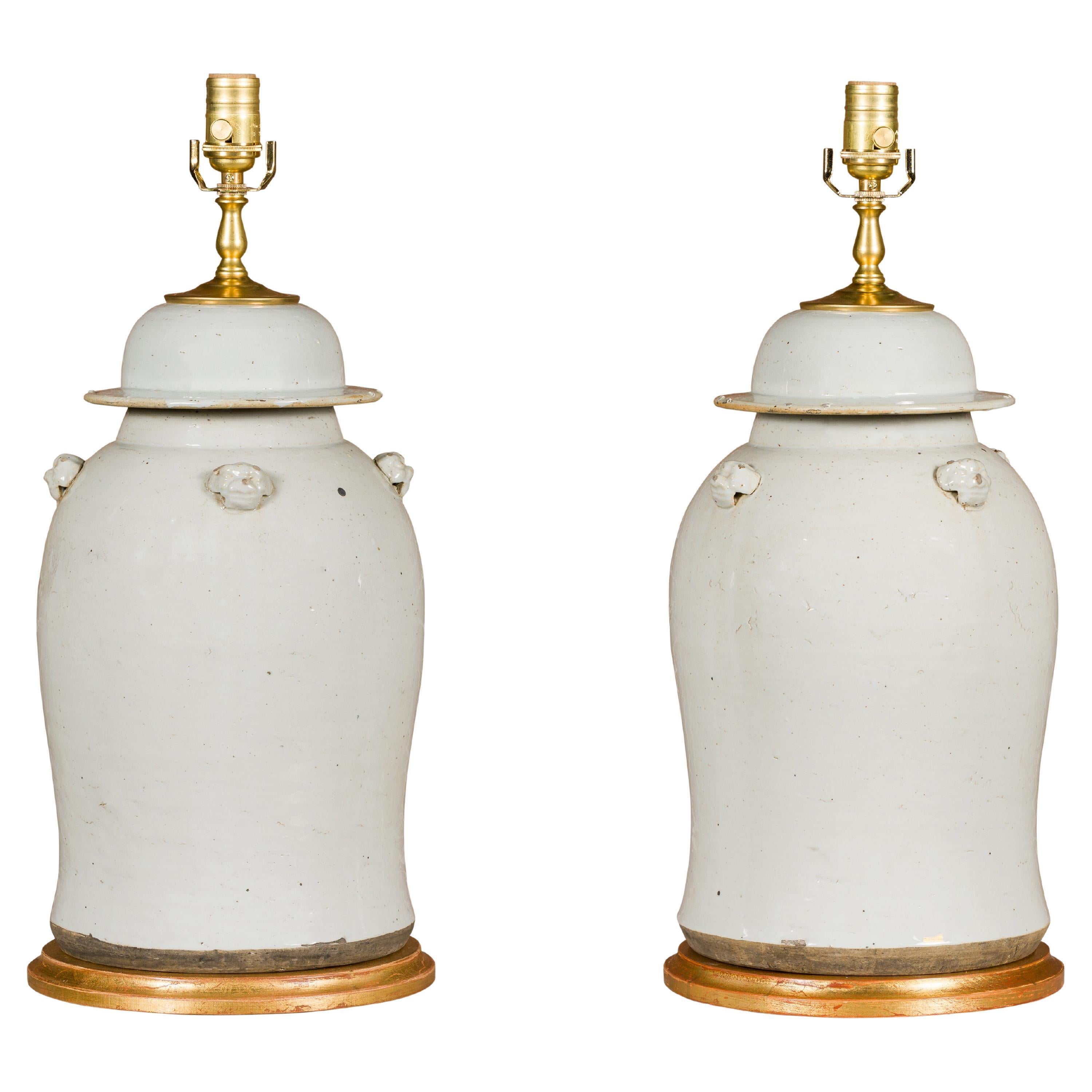 Pair of White Porcelain Lidded Urns Made into Table Lamps on Gilded Bases For Sale