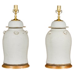 Pair of White Porcelain Lidded Urns Made into Table Lamps on Gilded Bases