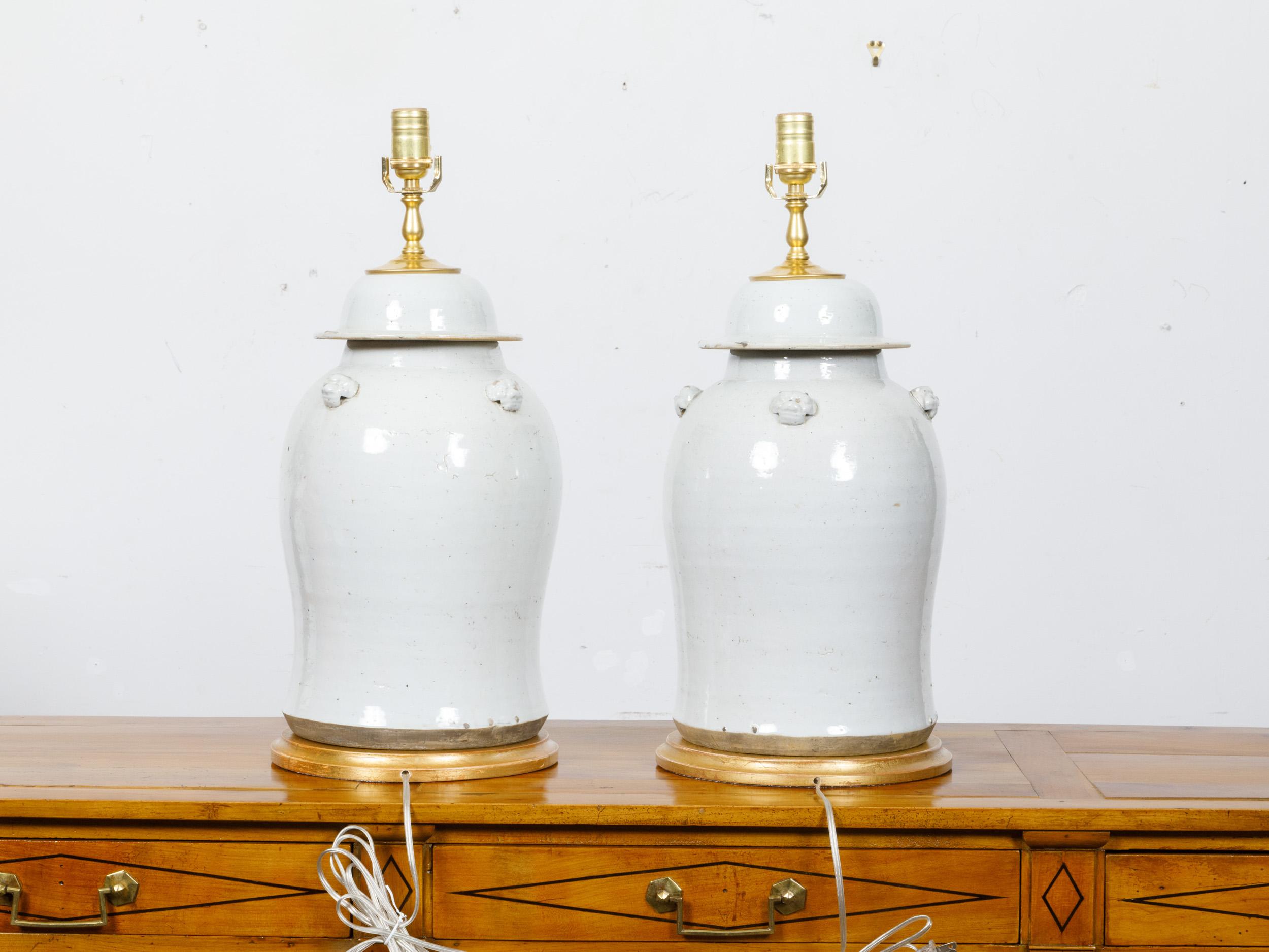 Pair of White Porcelain Lidded Urns Made into US-Wired Table Lamps on Gilt Bases In Good Condition For Sale In Atlanta, GA