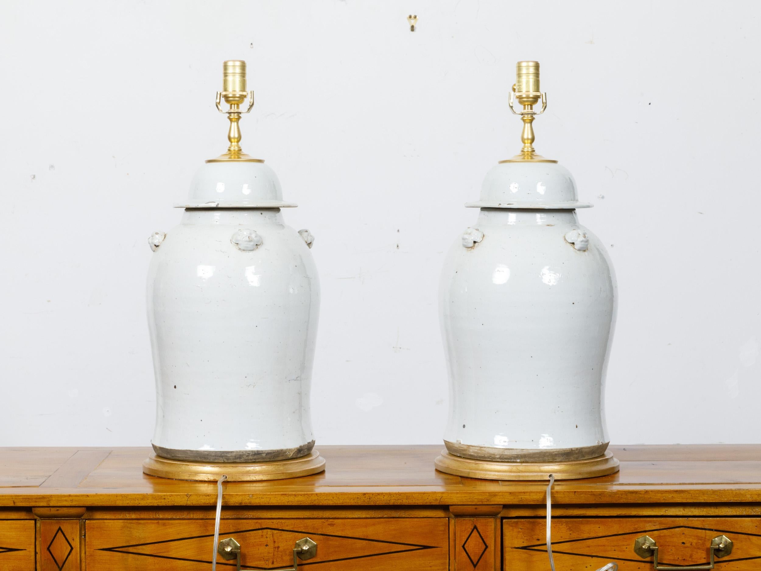 Glazed Pair of White Porcelain Lidded Urns Table Lamps on Gilt Bases, US-Wired For Sale