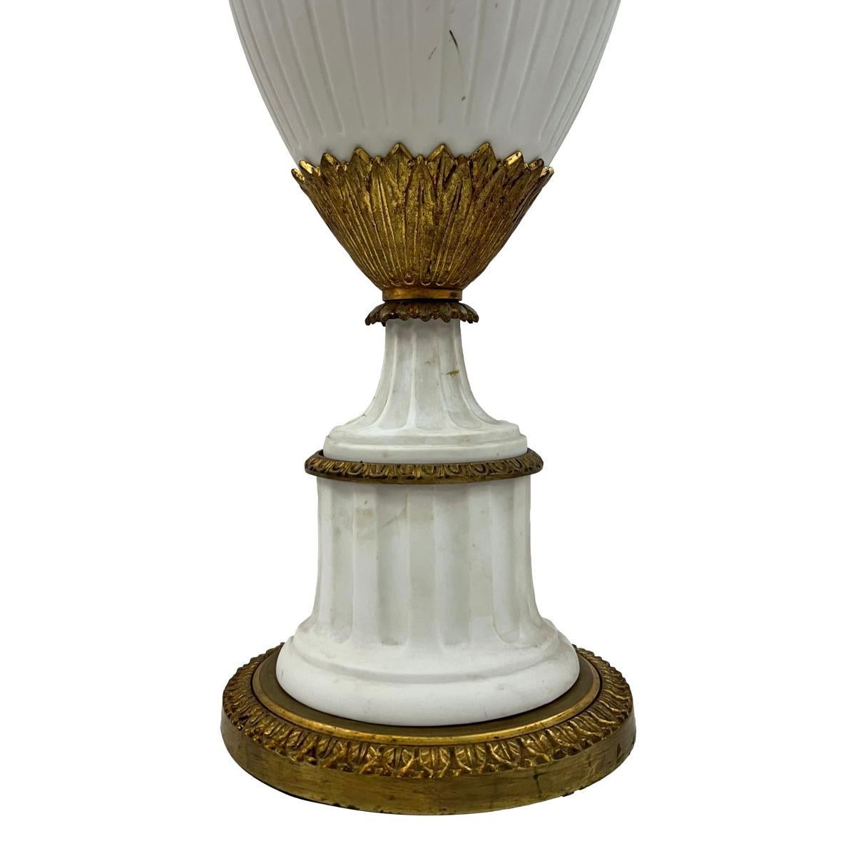 Pair of circa 1940's French porcelain table lamps with gilt bronze fittings.

Measurements:
Height of body: 23