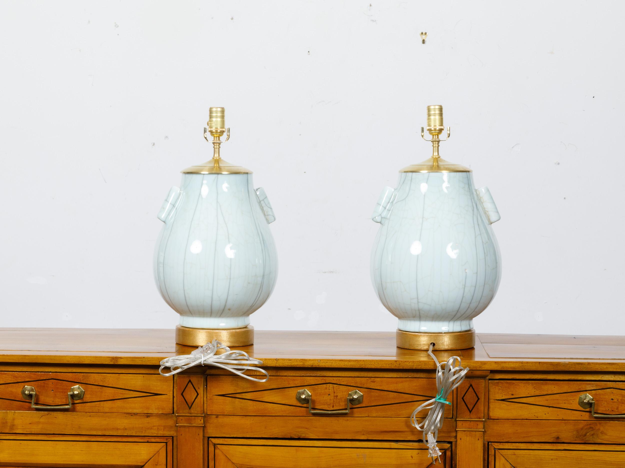 Gilt Pair of White Porcelain Tulip Shaped Vases with Crackle Finish Made into Lamps For Sale