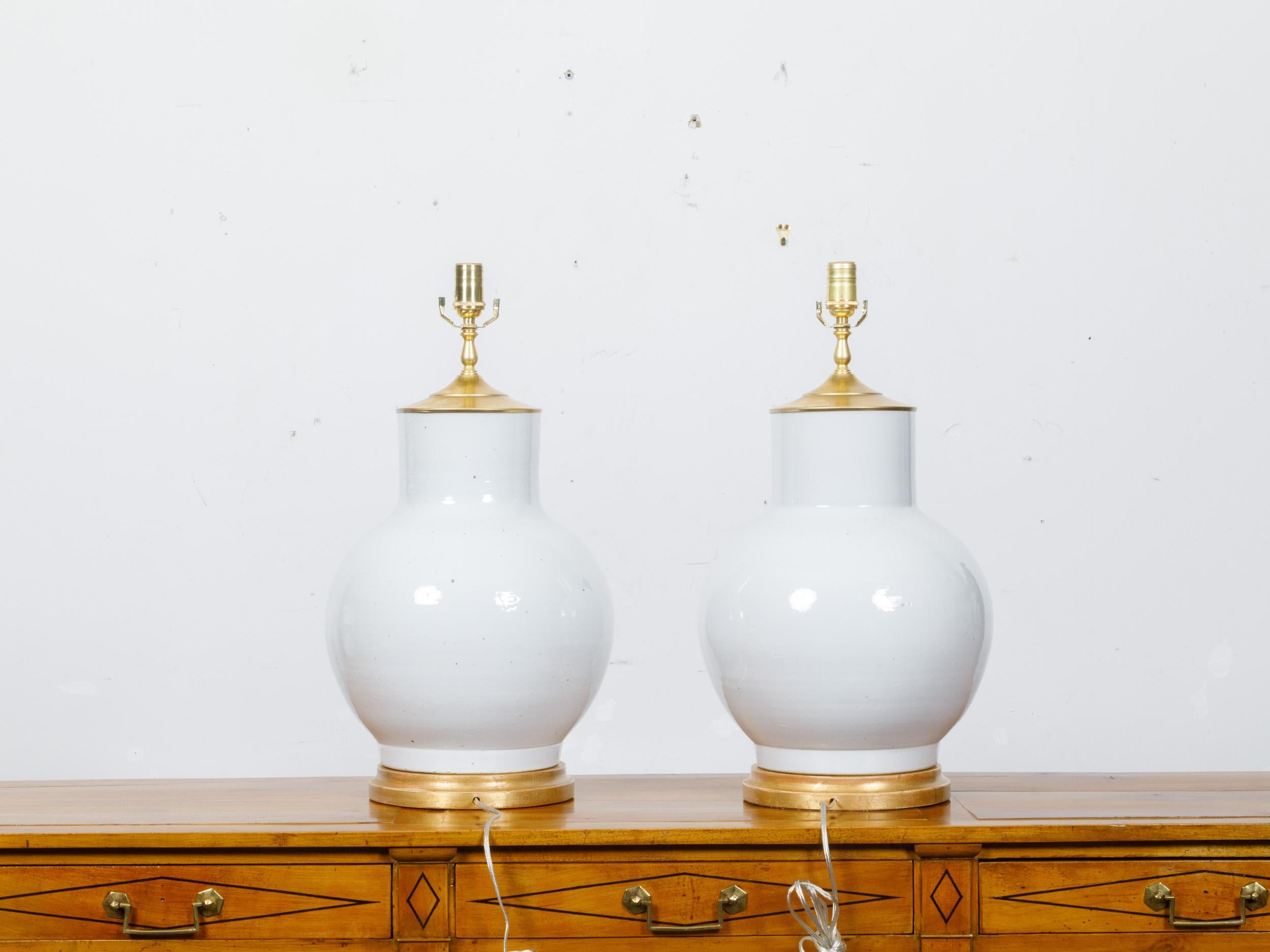 Pair of White Porcelain Vases Made into US-Wired Table Lamps on Giltwood Bases In Good Condition For Sale In Atlanta, GA