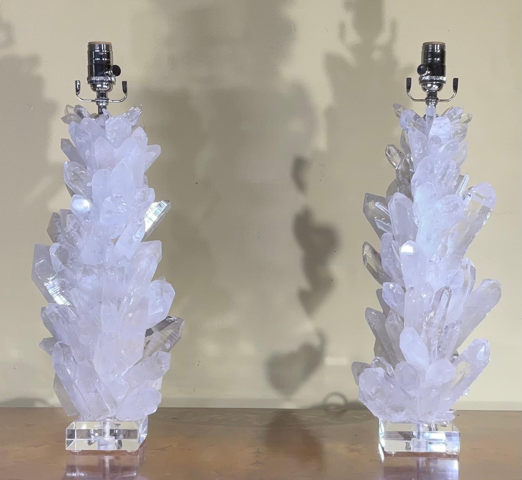 One of a kind pair of table lamps made of genuine crystal quartz shards and crystal points in white colors ,artistically put together to make beautiful and impressive pieces of object of art for display.
Bevelled clear Lucite base, size: 4”x 4”