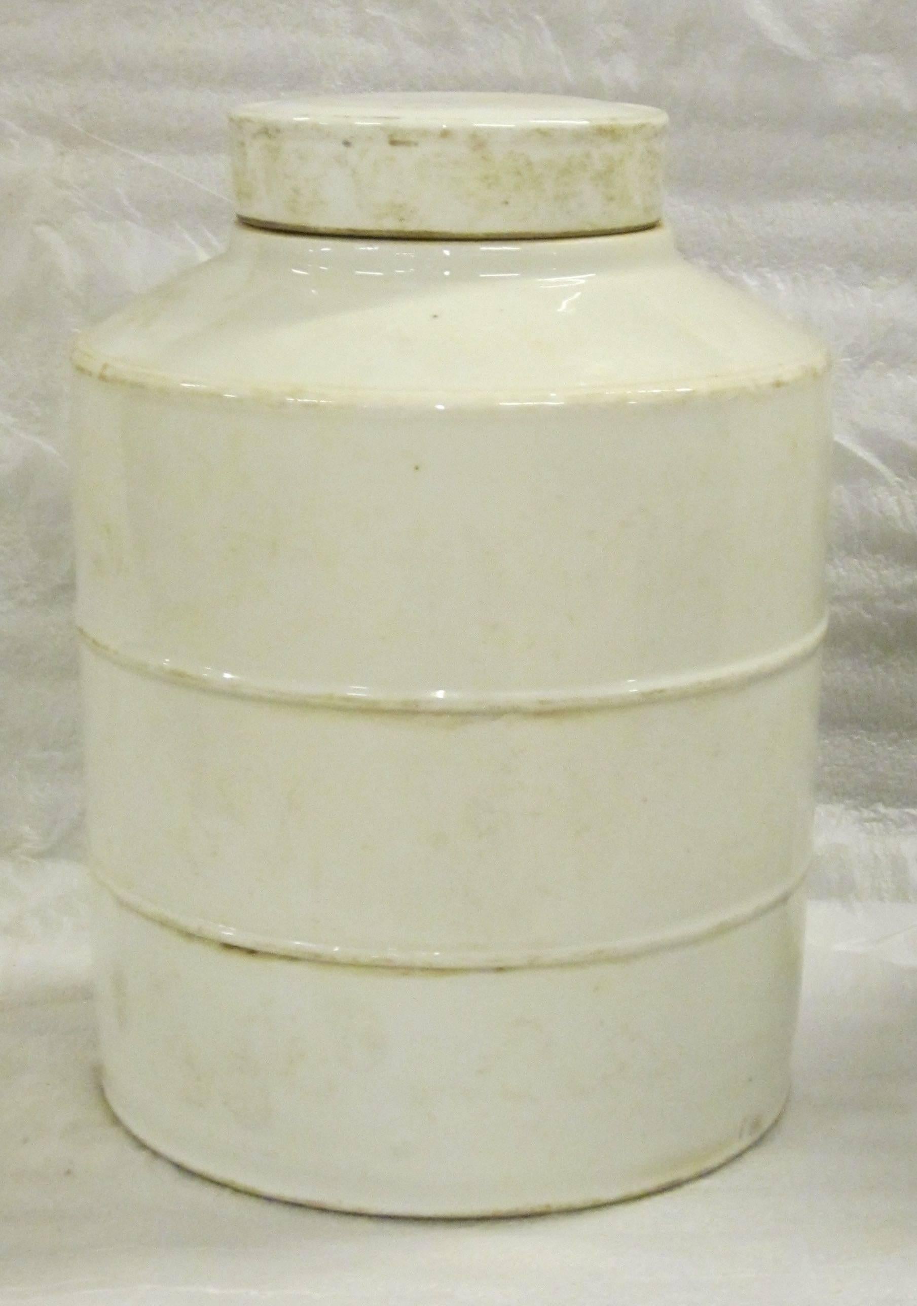 Contemporary Chinese pair of white ribbed round jars with lids.
Glaze has aged color detailing.
  