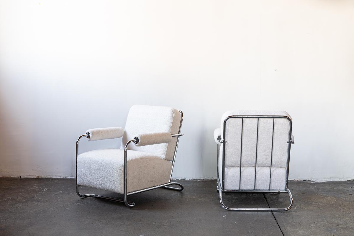 Pair of newly upholstered Gilbert Rhode chairs in white silk with chrome base.