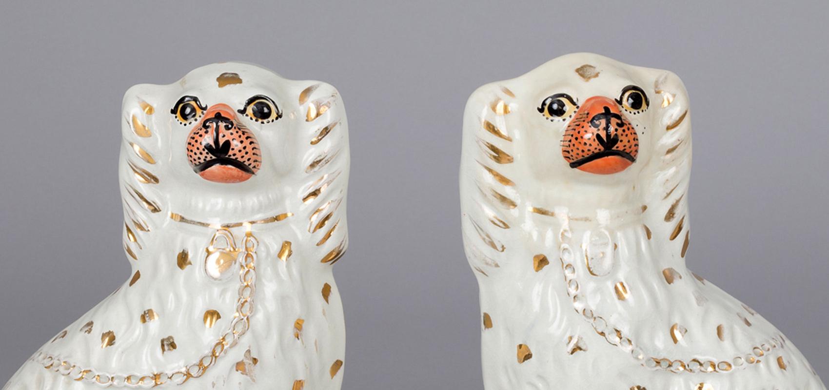 Pair of charming white Staffordshire dogs with flesh colored noses, gilded spots, collar and chain.