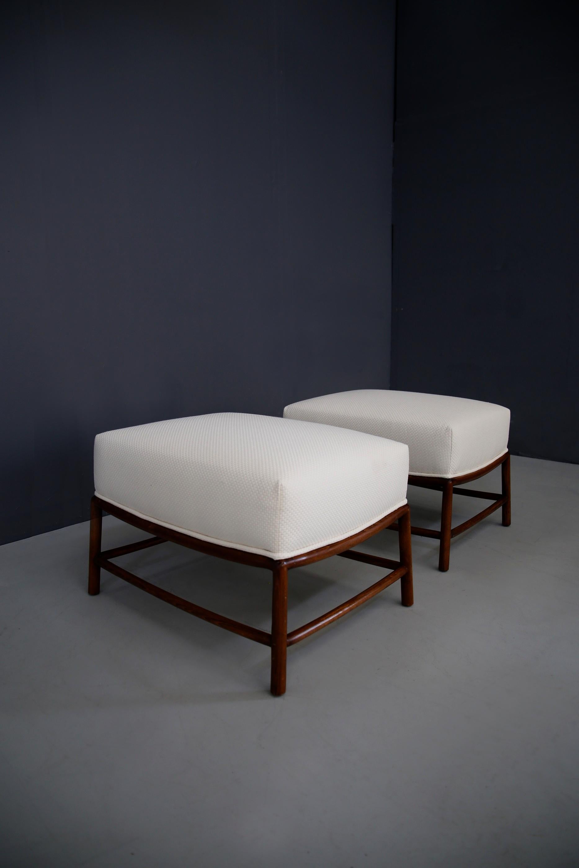 Rare pair of stools, pouf designed by T.H. Robsjohn-Gibbings of 1950 restored in a white cotton fabric. Their structure is in walnut wood. The pair is in perfect condition and is a beautiful piece of furniture. The poufs are ideal to complete the
