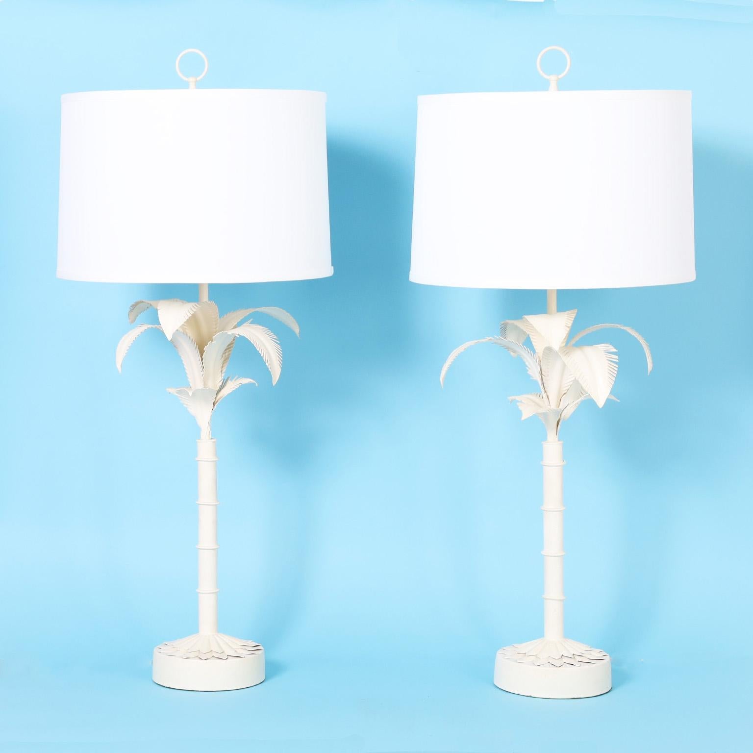 Chic pair of midcentury tole table lamps crafted with metal in a stylized form of palm trees with a white lacquer finish.