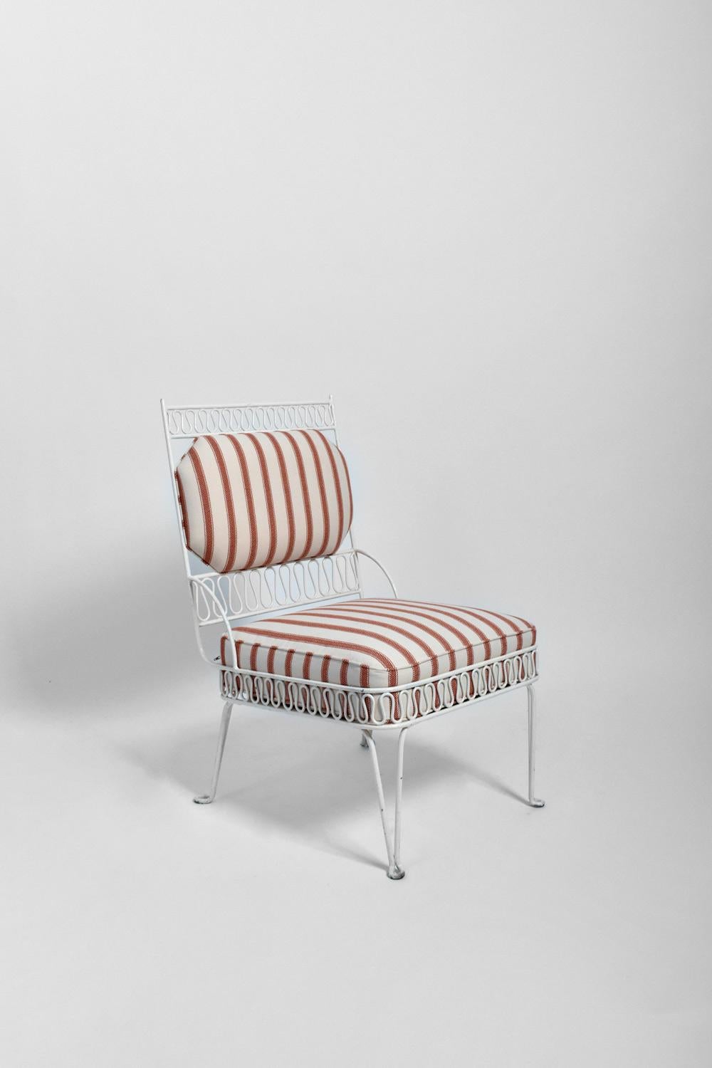 Pair of white painted tubular iron firesides armchairs with a ripple decoration on the belt and on the backrest . Spain, 1950s.
