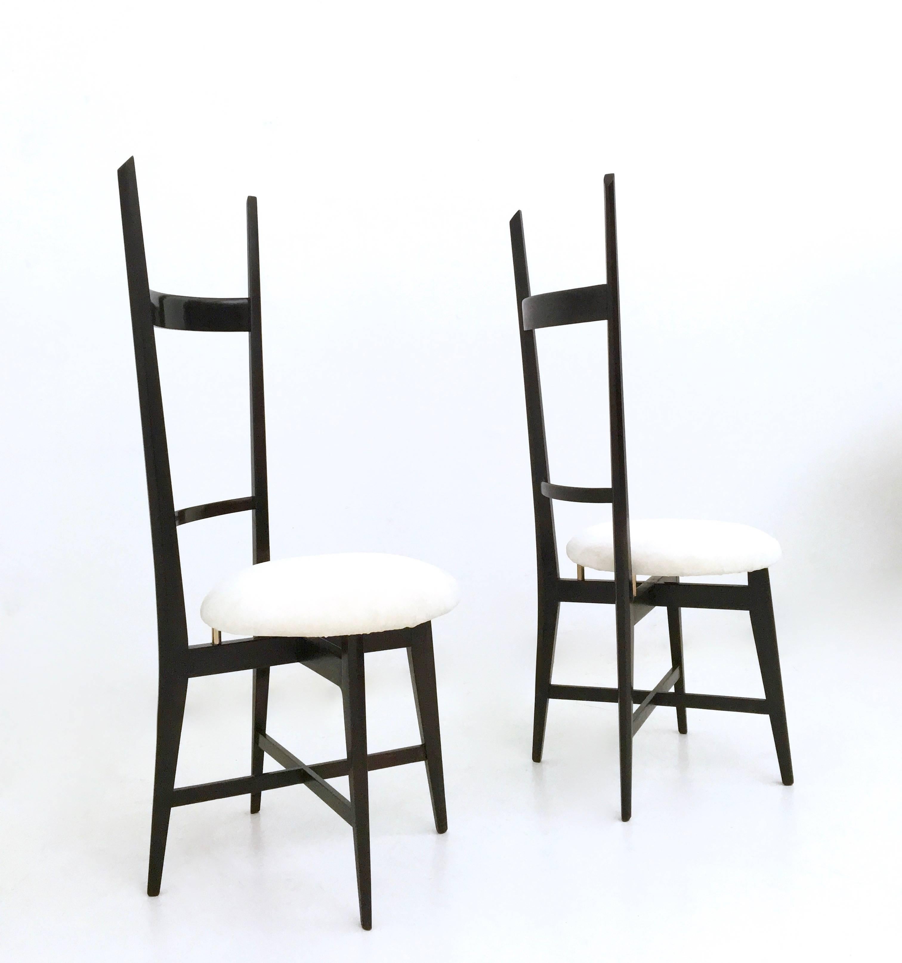 Made in Italy, 1950s.
These chairs feature a solid ebonized beech frame, brass details and white velvet upholstery.
They are vintage, therefore they might show slight traces of use, but since they have been restored they can be considered as in