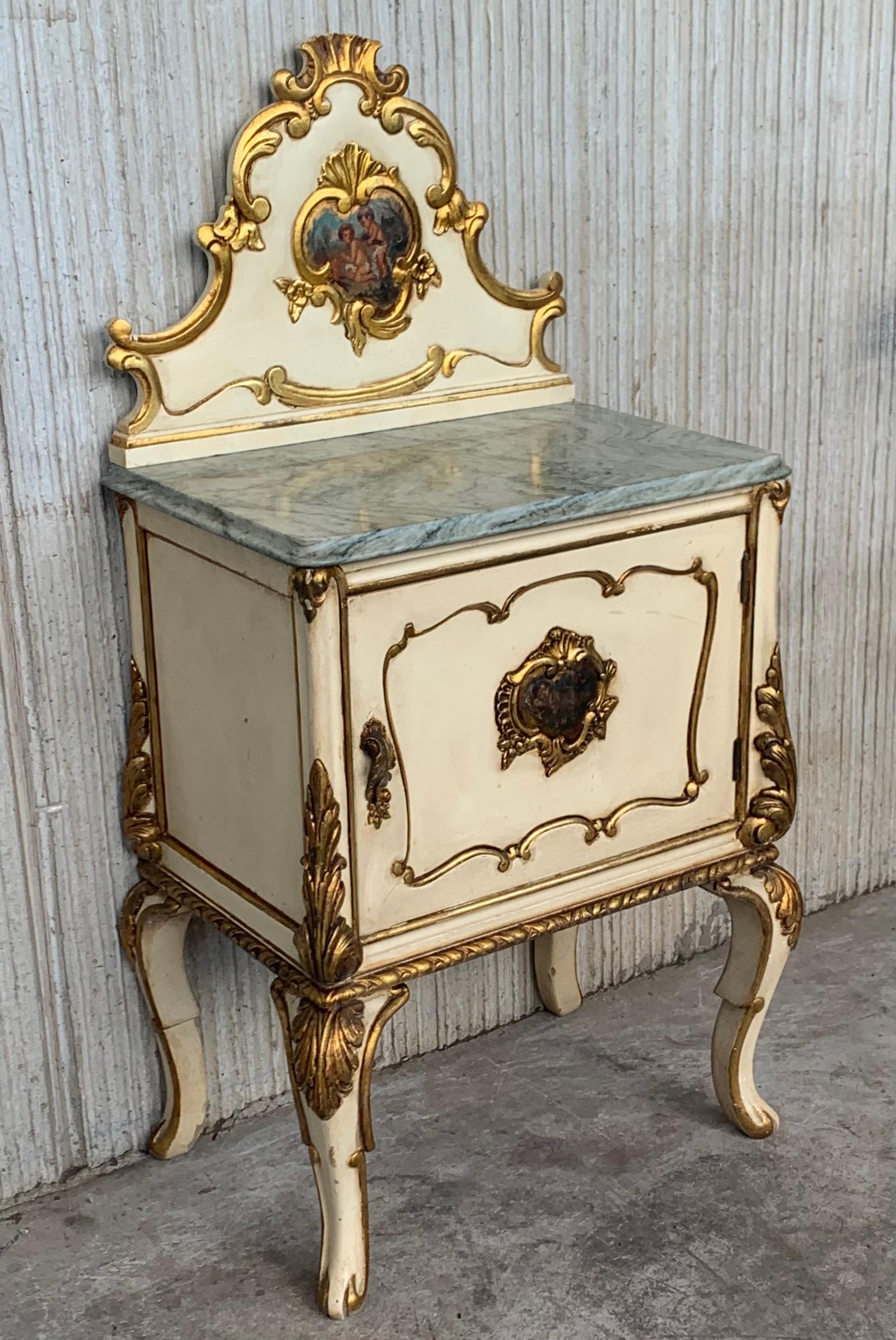 Pair of Cream White Neoclassic nightstands with beautiful light green marble top. The tables have a gilt wood decoration in crest and legs... an so a beautiful handpainted pictures in the crest and doors. The pictures of the crest depicting a a pair