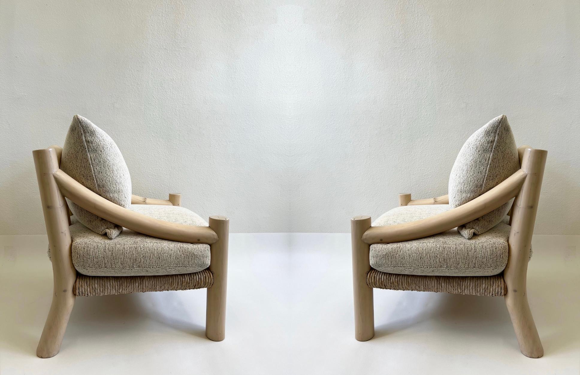 1980s Pair of “Douglas” Lounge Chairs by Michael Taylor. 
Constructed of white washed wood and rush with new down filled off white chenille fabric cushions. 
The frames are in original condition, so they show minor wear consistent with age.