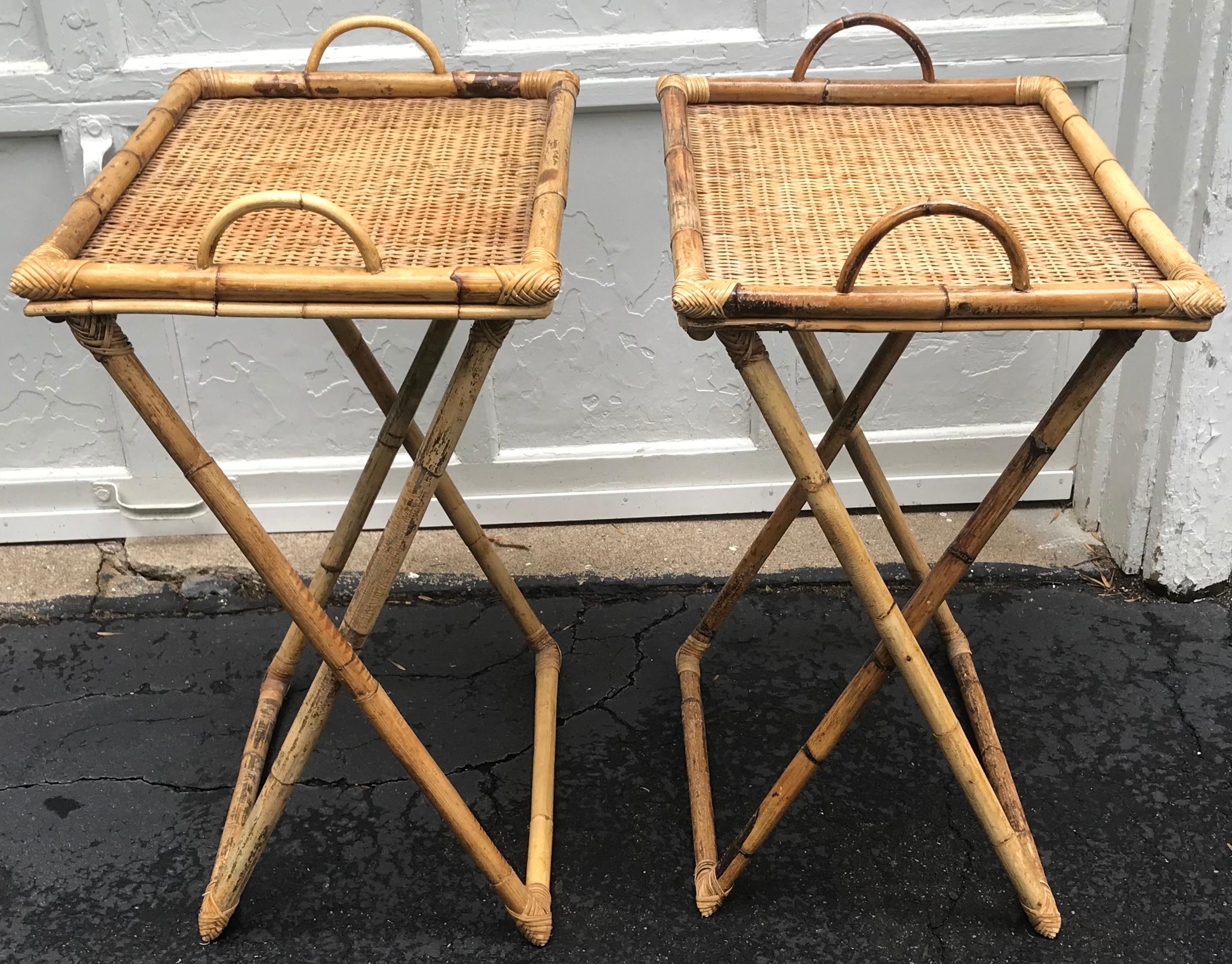 Pair of wicker and bamboo tray tables. Pair of vintage wicker and bamboo handled trays on collapsible stands perfect as bedside tables at the beach or chic dinners in front of the television. Stands fold up for convenient minimal storage with trays,