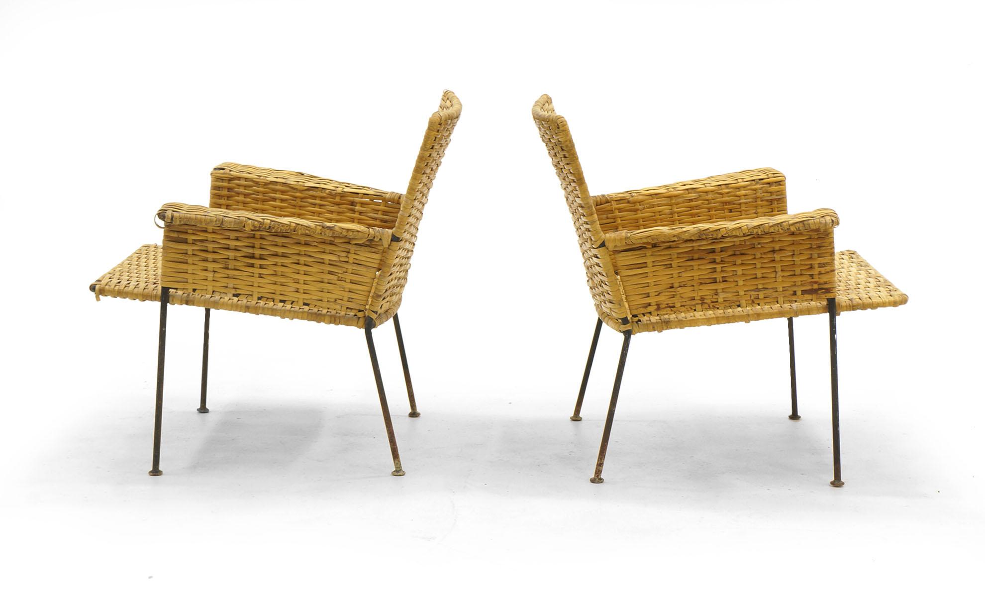 Pair of Van Keppel and Green wicker and wrought iron lounge chairs. Attractive wear to both the wicker and legs. Great for use outdoors or on a porch. We have meticulously cleaned the wicker.