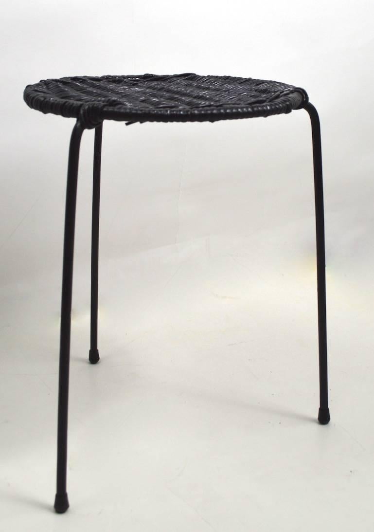 Pair of diminutive Wicker top, wrought iron base stands designed by Arthur Umanoff.
Offered and priced individually but we would love to see them stay together,
currently in later black paint finish.