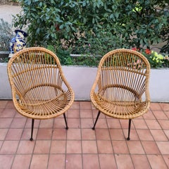 pair of wicker armchairs and black lacquered metal foot Italy circa 1960
