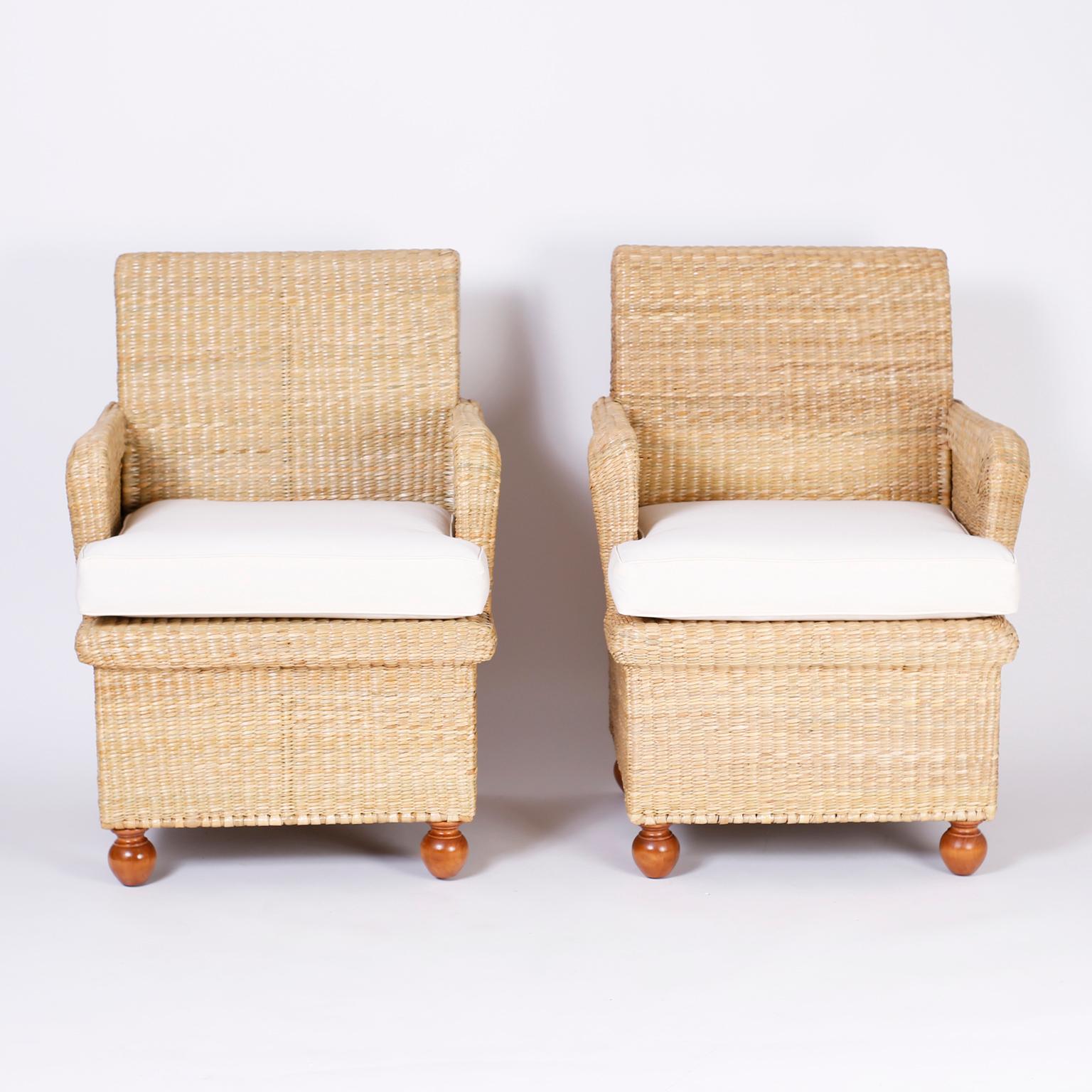 British Colonial armchairs crafted with a sturdy metal frame ambitiously wrapped in reed with comfort and classic form set on turned wood feet. Exclusively designed and offered by F.S. Henemader Antiques from the FS Flores collection. Priced per