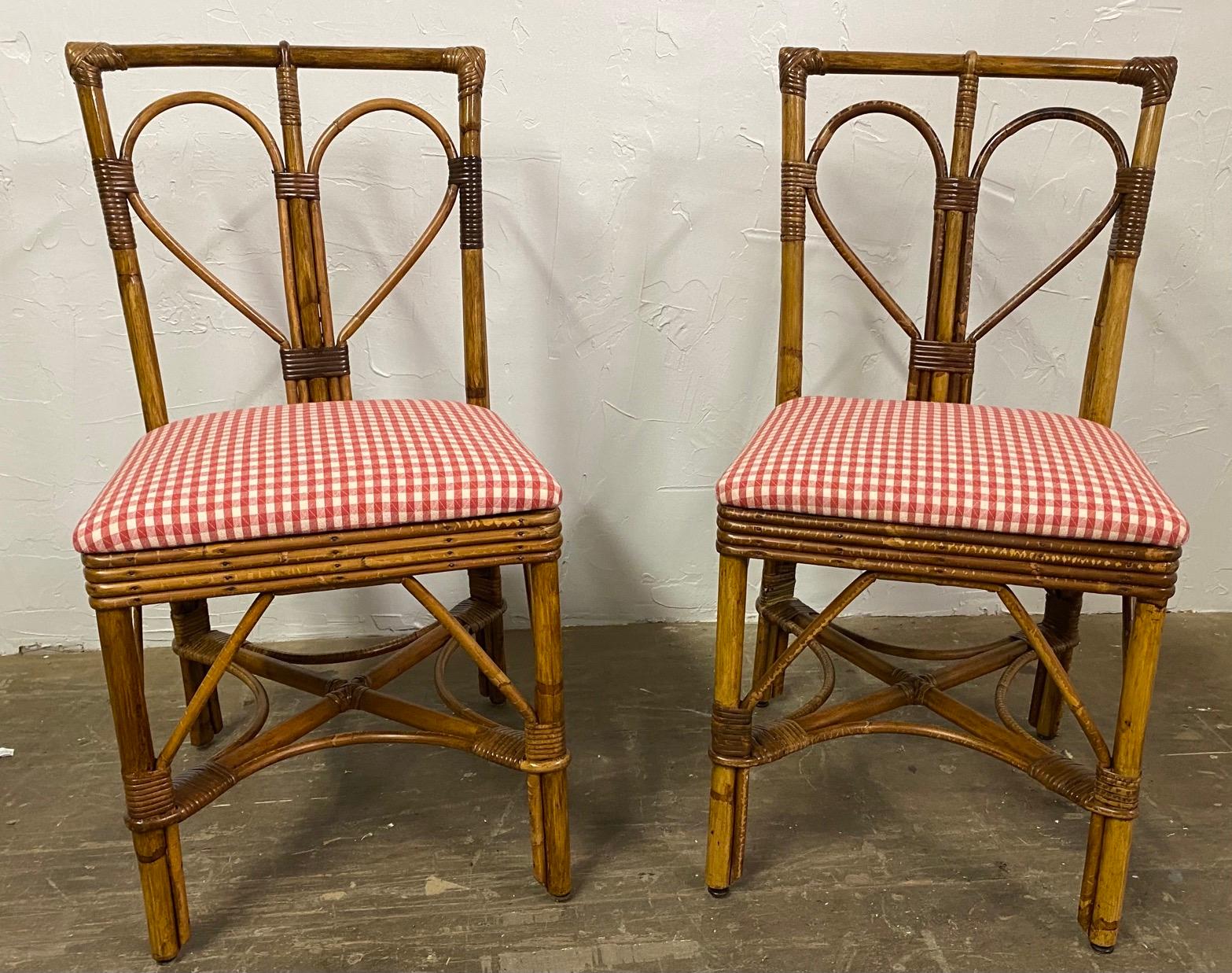 Pair of charming rattan bamboo side chairs covered red and white checkered fabric seat cushions.
Great as kitchen dining chairs or extra chairs for the porch or patio.