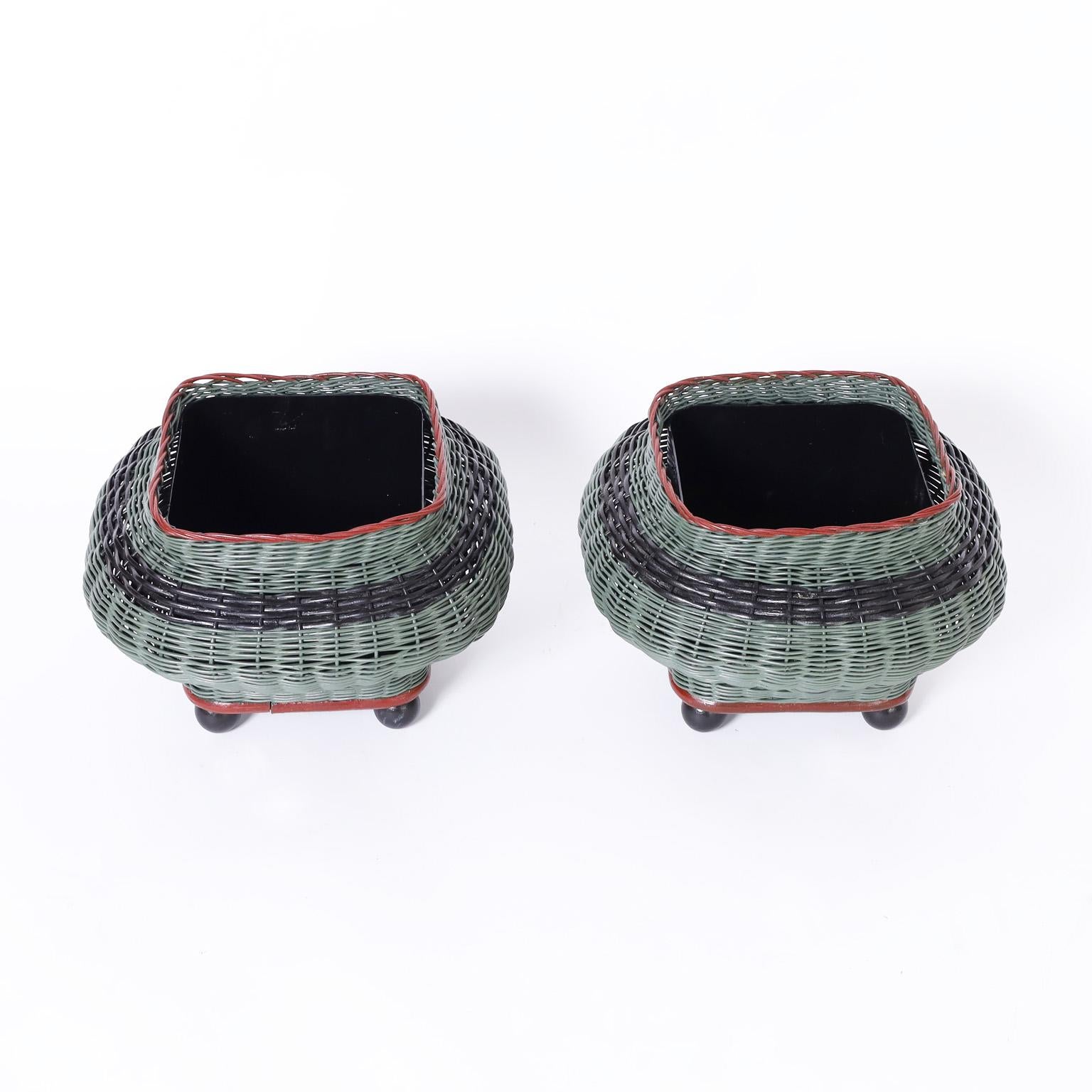 Unusual pair of vintage planters crafted in stick wicker in a Bombay form painted and raised on classic ball feet.