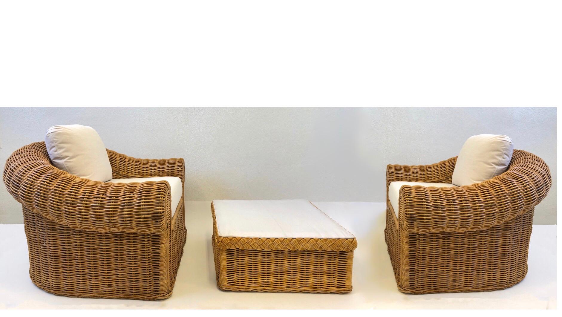 A spectacular 1980s pair of large scale wicker lounge chairs and ottoman in the style of Michael Taylor. Newly recovered with off white Sunbrella fabric. The ottoman could be used as a cocktail table without cushion.
Measurements:
Chair- 42” wide,