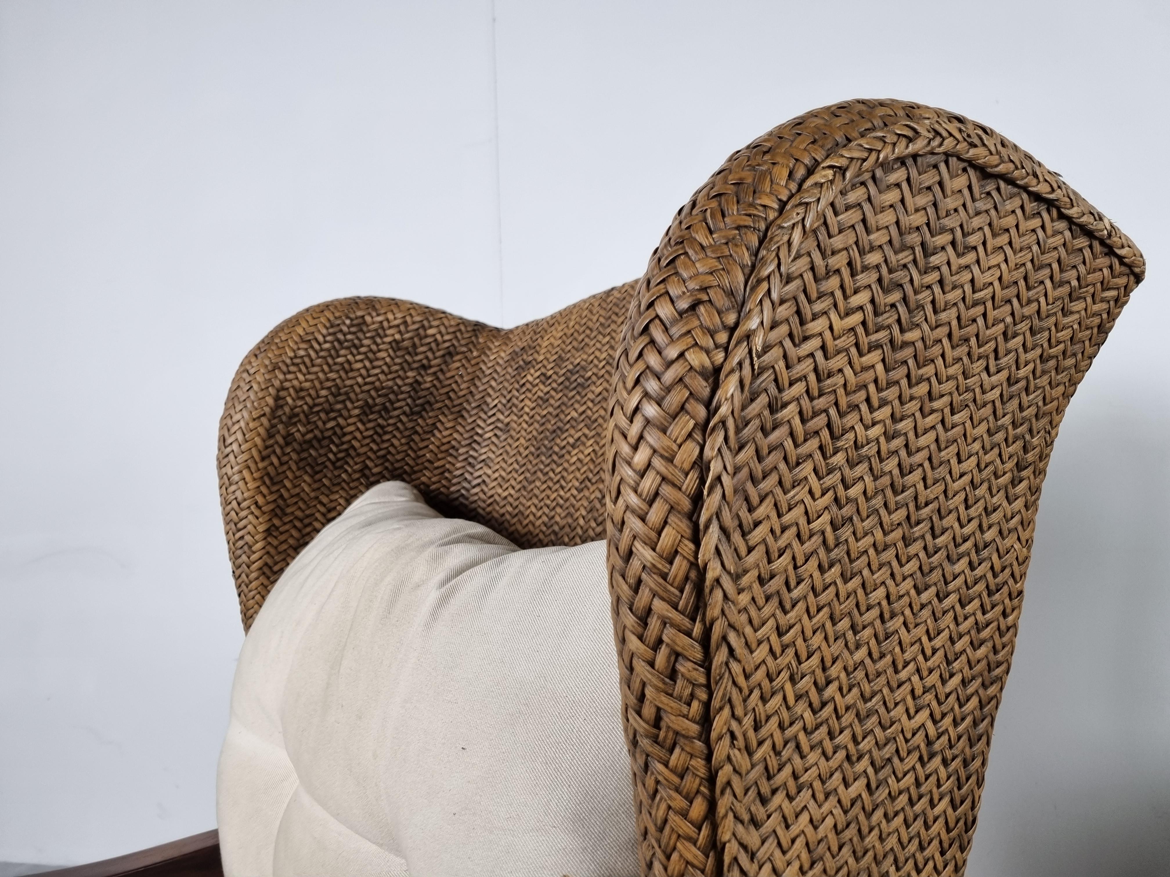 Very charming wingback chairsm adefrom braided wiker and bamboo.

Elegantly shaped chairs with wooden armrests.

The cushions are non original and can be replaced if needed.

1950s - France

Good overall condition, cushions are comfortable