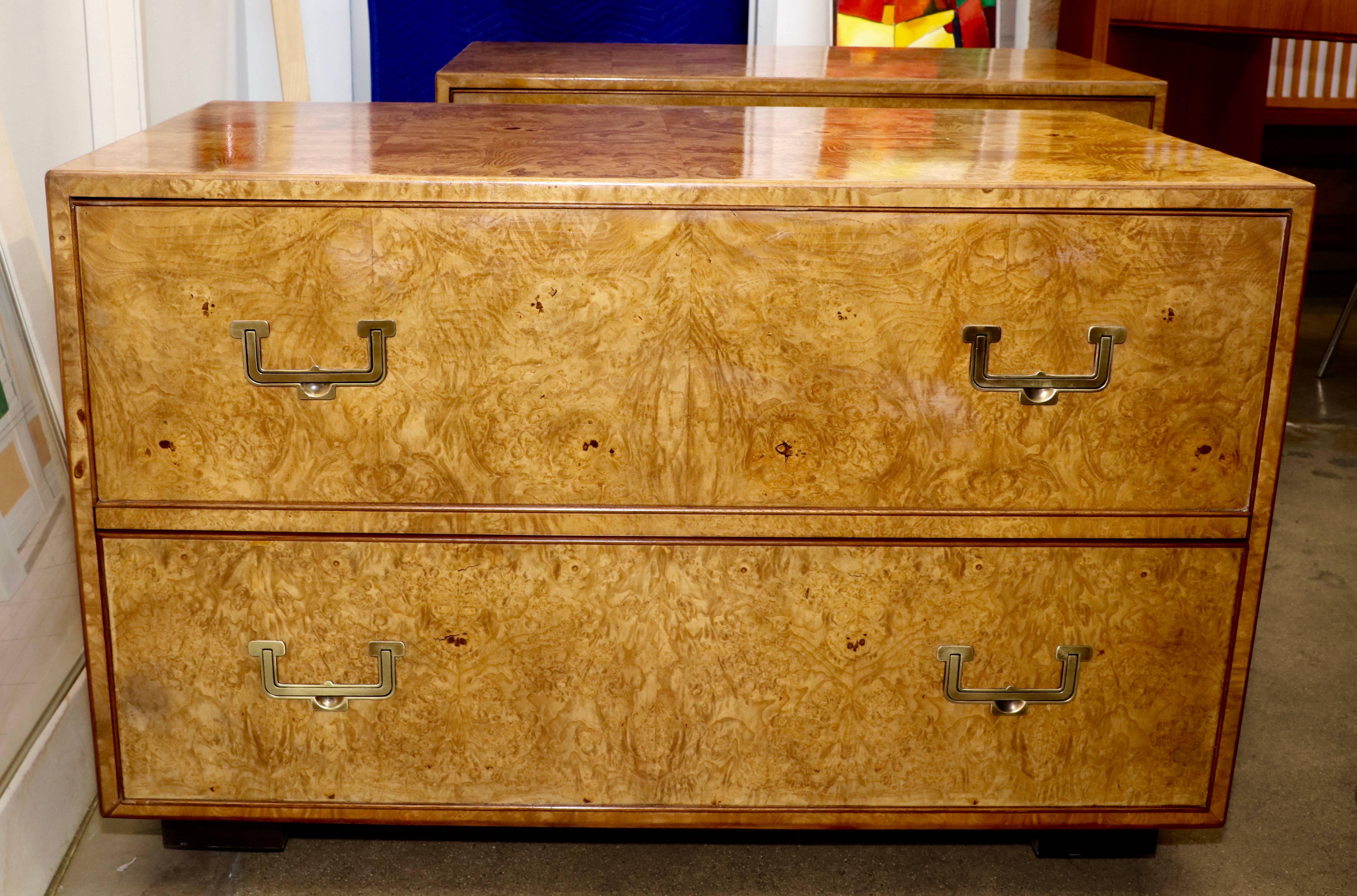 A nice pair of Campaign style end tables or nightstand veneered in a nice fuel finish. These stand have two drawers each and feature the Widdicomb gold label. They have had the tops redone, which are a little glossier than the sides. One drawer has