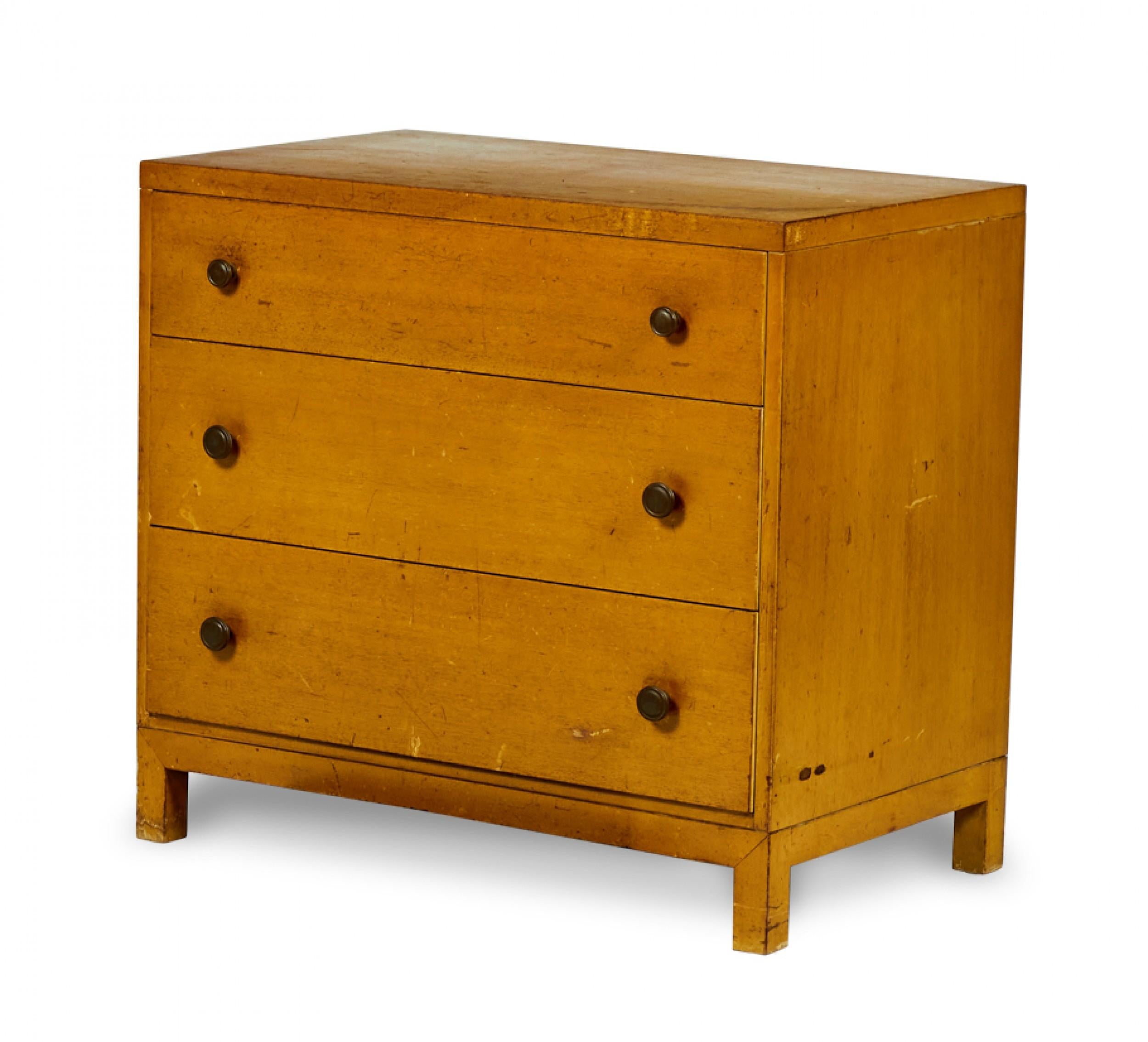 PAIR of American Mid-Century walnut commodes / chests with three drawers and round brass drawer handles resting on bracket-shaped bases with four legs. (WIDDICOMB MODERN)(PRICED AS PAIR(Similar chest: DUF0151C)
